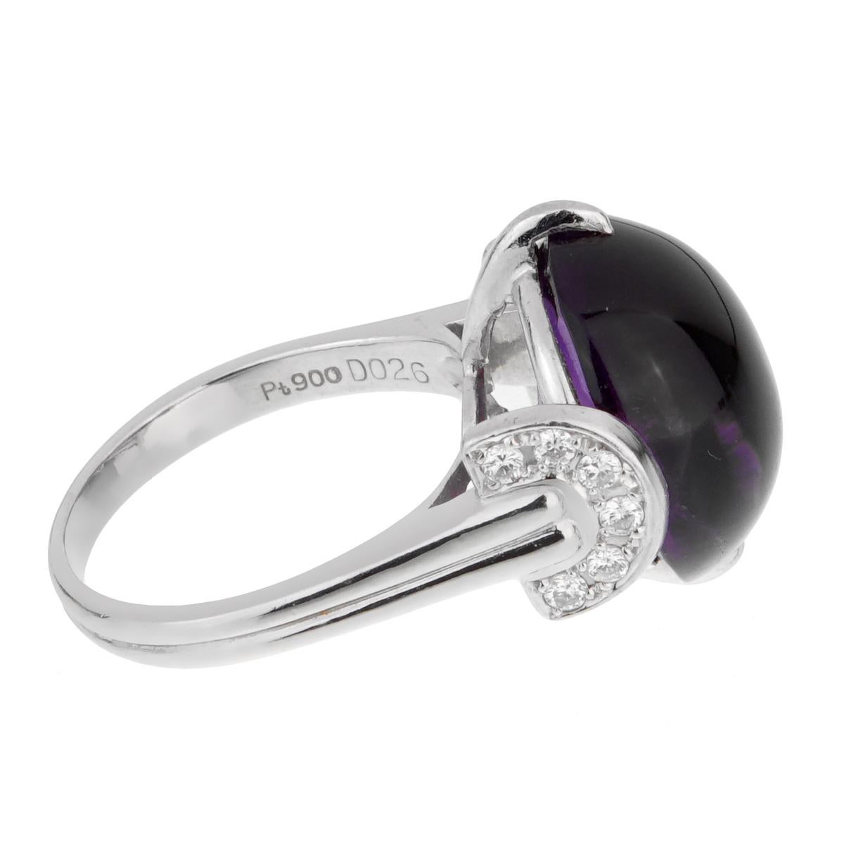 A magnificent Christian Dior diamond ring featuring an oval cabochon amethyst adorned with 12 of the finest round brilliant cut diamonds set in platinum. Size 7