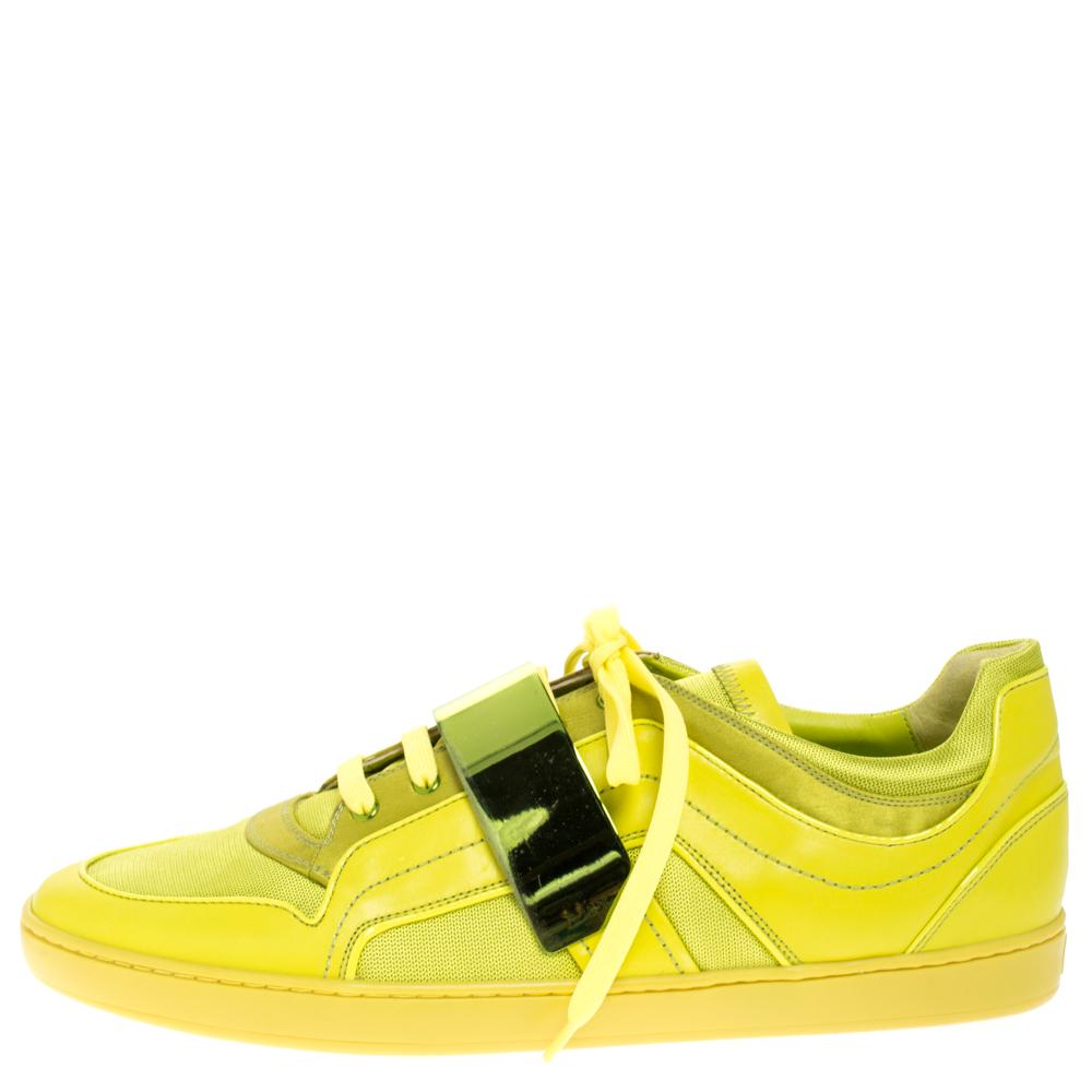 Sneakers are all the rage now when it comes to trendy footwear. Join the style wave with these incredibly appealing pair by Dior. The kicks are crafted from leather in mesmerizing apple green and they are detailed with a metallic strap over the