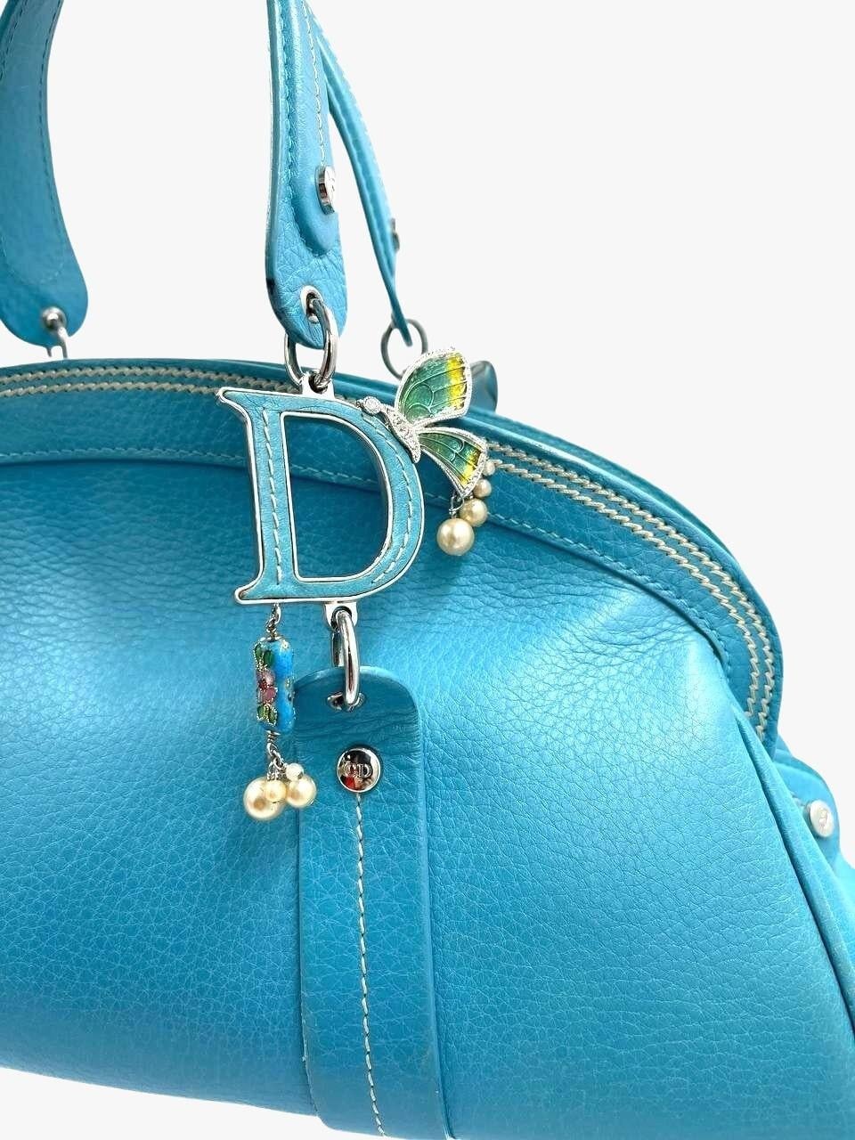 Rare Dior structured blue top-handle bag from Spring-summer 2003 collection designed by John Galliano. 
The collection was inspired by Asia. 
The handles are decorated with monogram (C and D letters) and enamel butterflies, rhinestones and faux
