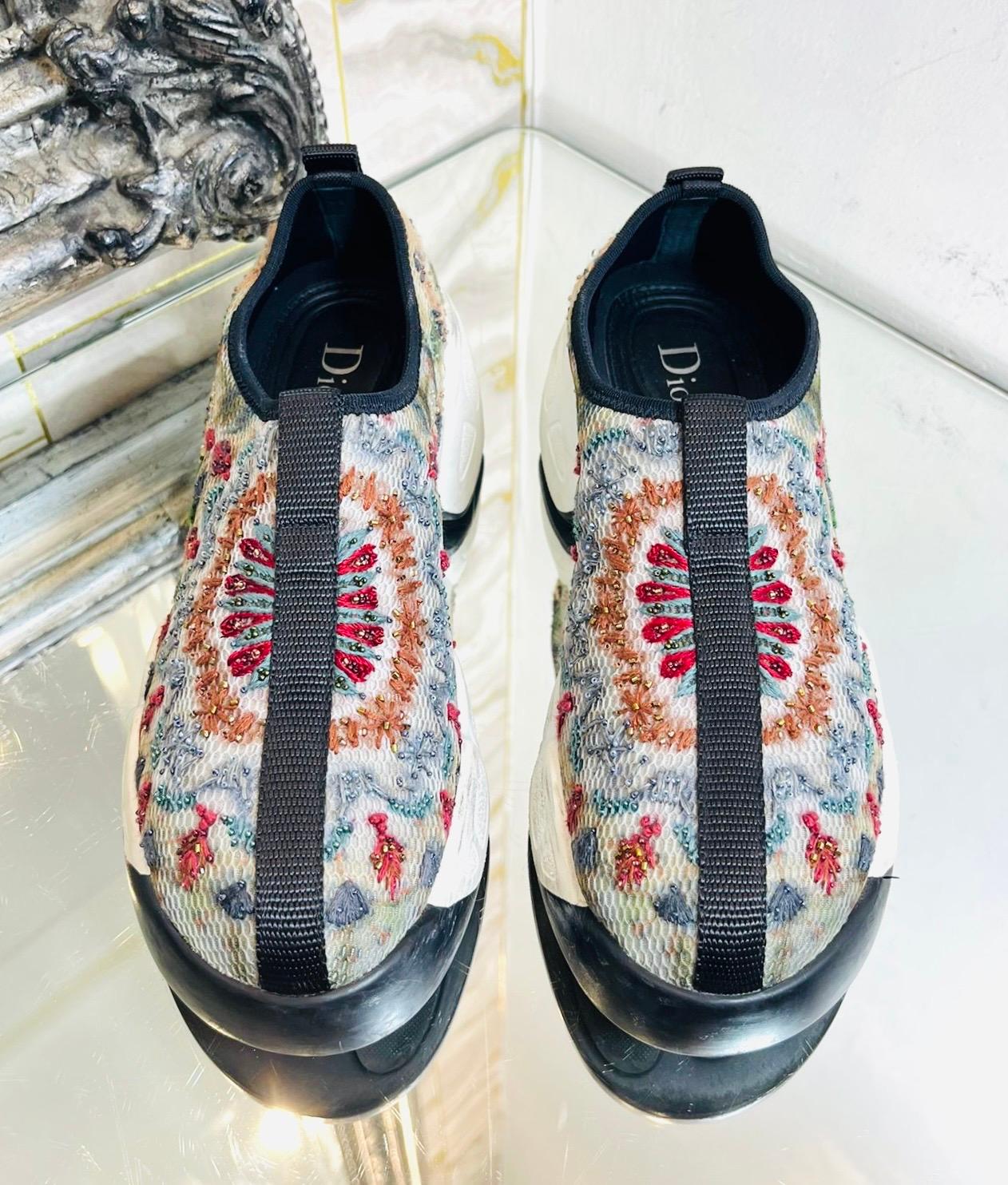 Dior Bead Embroidered Mesh Sneakers

Off-white slip-on sneakers designed with multicoloured, bead embellished embroideries.

Featuring 'Dior' engravement on a white rubber platform with black detailing to the toe and stripe through the centre.

Size