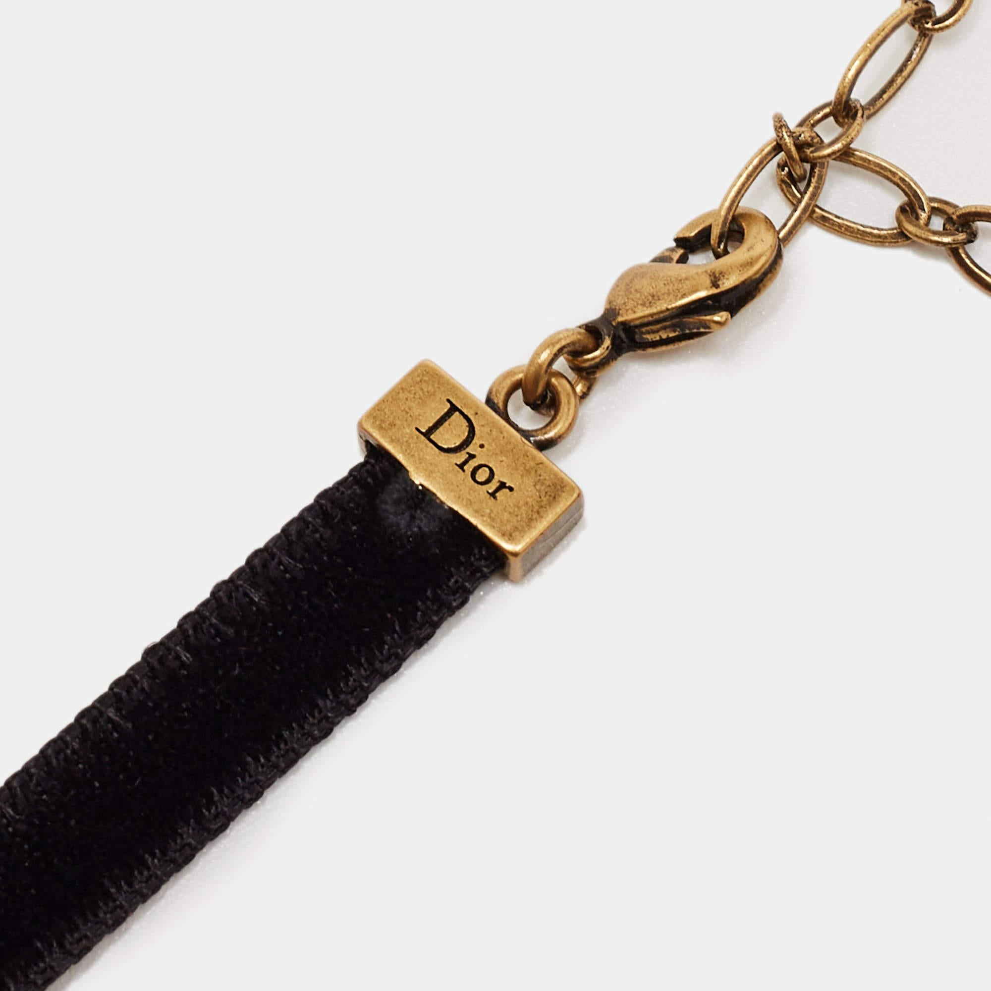 Accessories that are high on style are absolutely worth the buy, such as this choker by Dior. It has been so well assembled with the bee motif in gold-tone metal with crystals while being held by a fabric-tape that has a lobster clasp. The choker