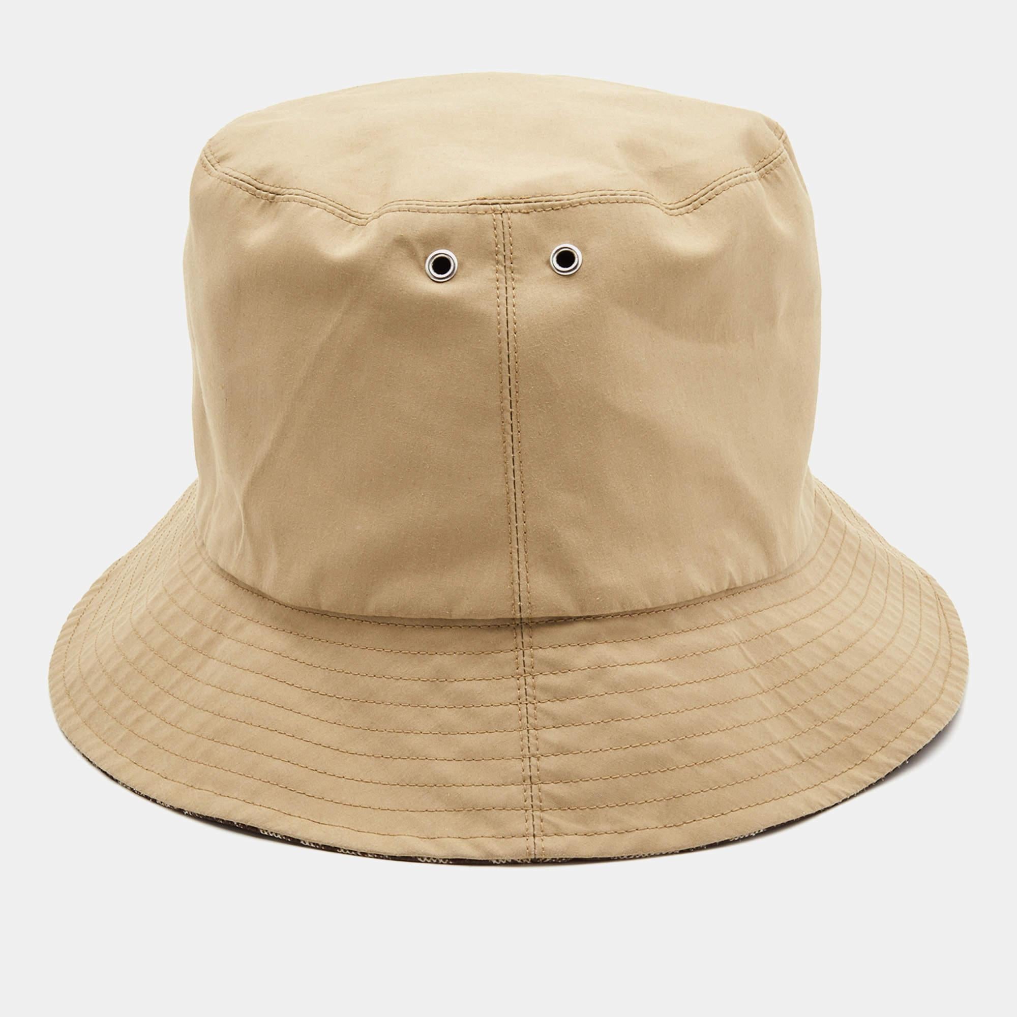 The Dior Teddy-D bucket hat is a stylish and versatile accessory. Its iconic oblique pattern and teddy bear motif showcase Dior's elegance. The hat is reversible, featuring a beige side and a brown side, allowing for multiple looks. The brim