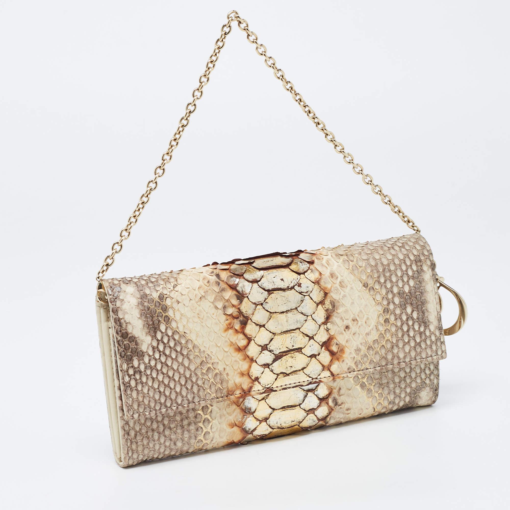 This Lady Dior WOC is a coveted piece that every fashionista craves to possess. This beige WOC has been crafted from python and leather and it carries a lovely exterior. It is equipped with a leather and fabric interior featuring multiple card slots