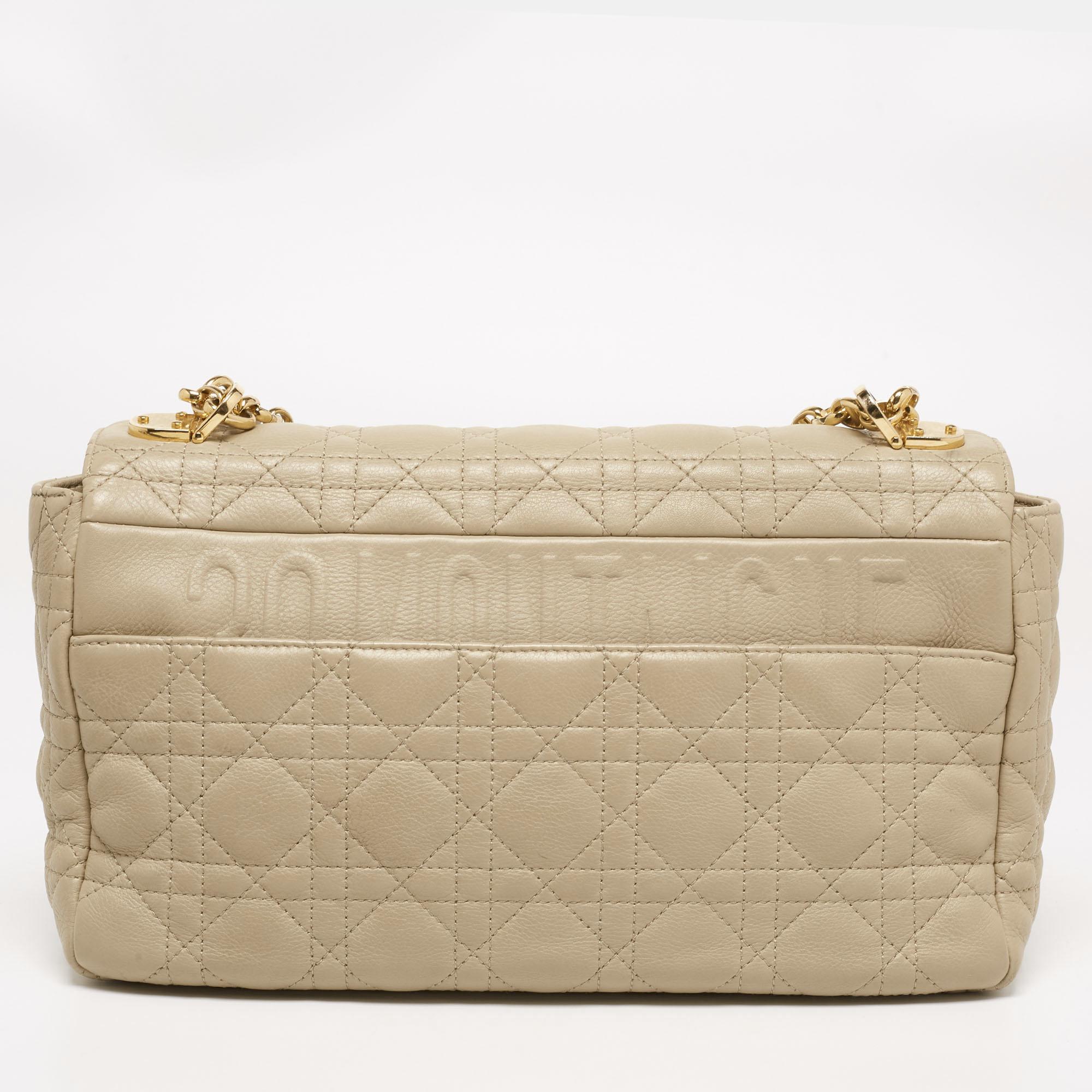 This shoulder bag from Dior is the bag of every woman's dream! It has a Cannage leather exterior with stunning gold-tone details. The beige creation is a perfect example of excellent craftsmanship.

