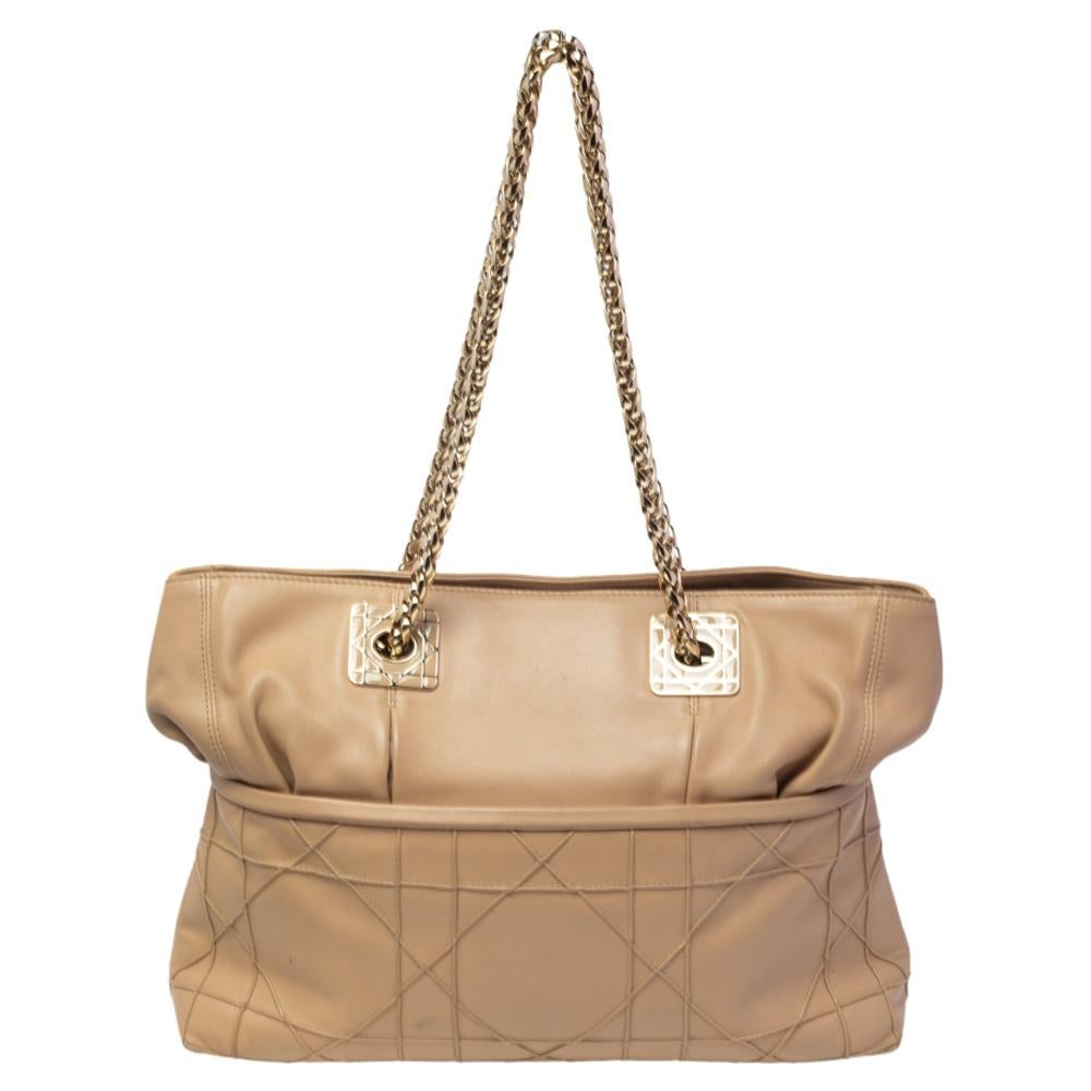 This Granville tote from Dior is a bag that every fashionista craves to possess. The tote has been crafted from leather, and it carries a lovely beige exterior accented with the signature Cannage pattern. It is equipped with a spacious interior and
