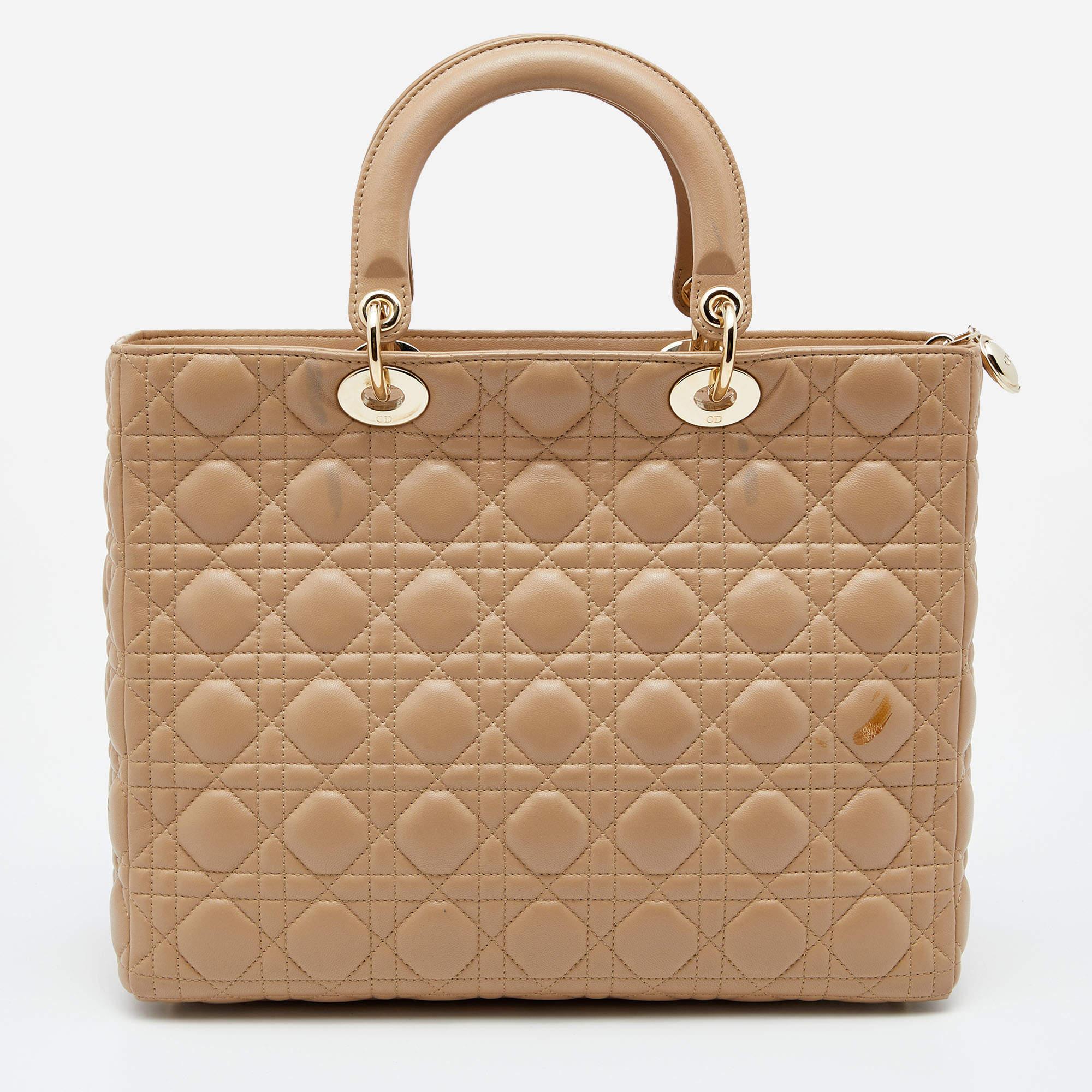 A timeless status and great design mark the Lady Dior tote. It is an iconic bag that people continue to invest in to this day. We have here this Lady Dior tote crafted from Cannage leather. The bag is complete with two top handles, a shoulder strap,