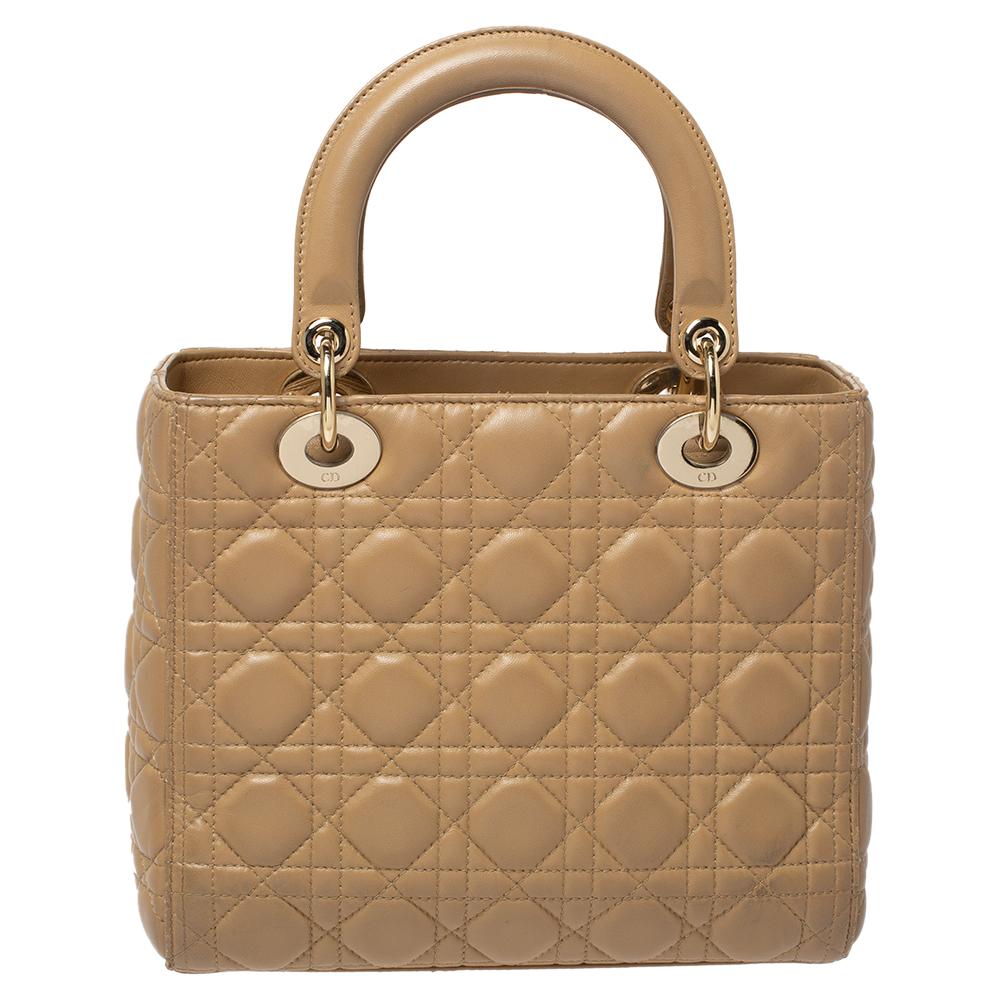 The Lady Dior tote is a Dior creation that has gained recognition worldwide and is today a coveted bag that every fashionista craves to possess. This beige tote has been crafted from leather and it carries the signature Cannage quilt. It is equipped