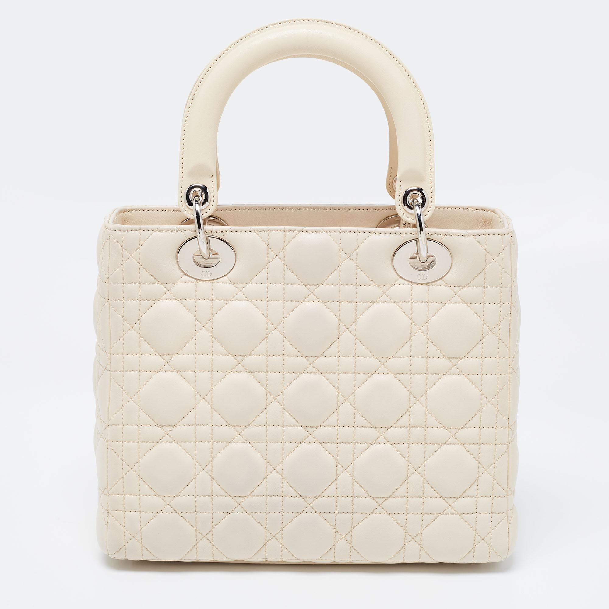 The Lady Dior tote is a Dior creation that has gained wide recognition is a coveted bag that every fashionista wants to possess. The beige tote has been crafted from patent leather and carries the signature Cannage quilt. It is equipped with a nylon