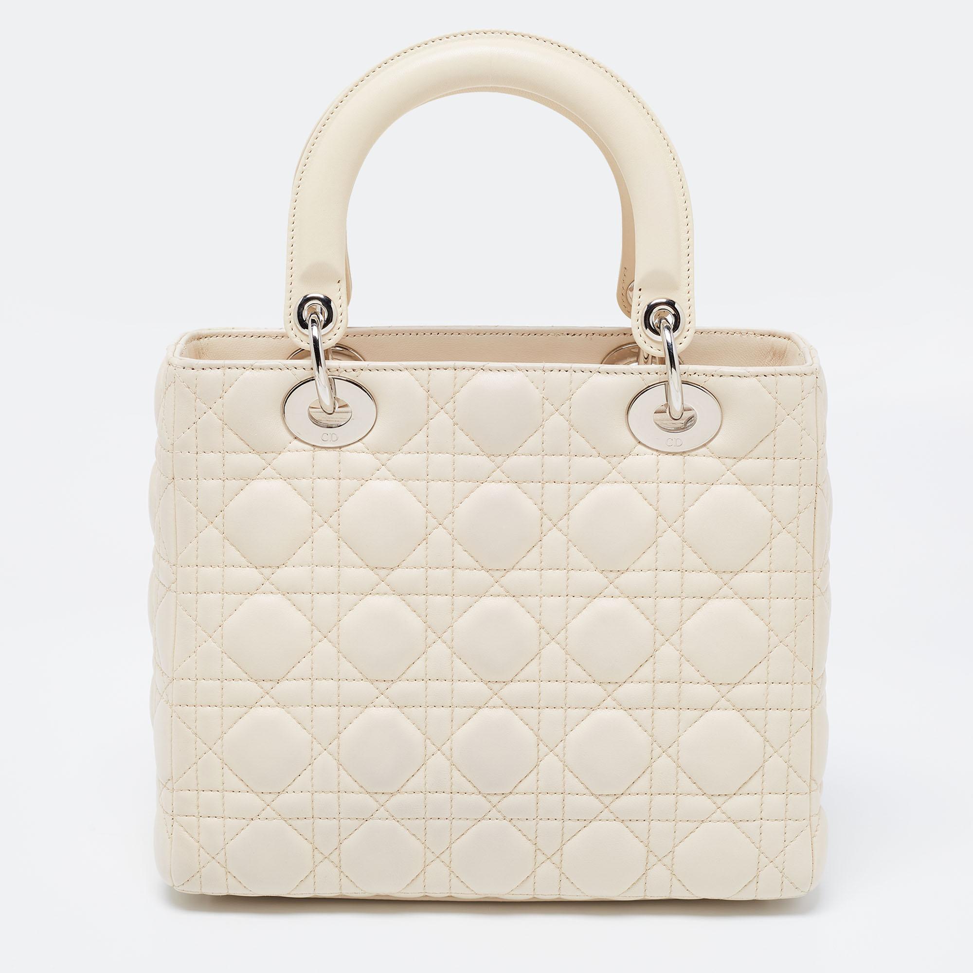 The Lady Dior tote is a Dior creation that has gained wide recognition is a coveted bag that every fashionista wants to possess. The beige tote has been crafted from patent leather and carries the signature Cannage quilt. It is equipped with a nylon