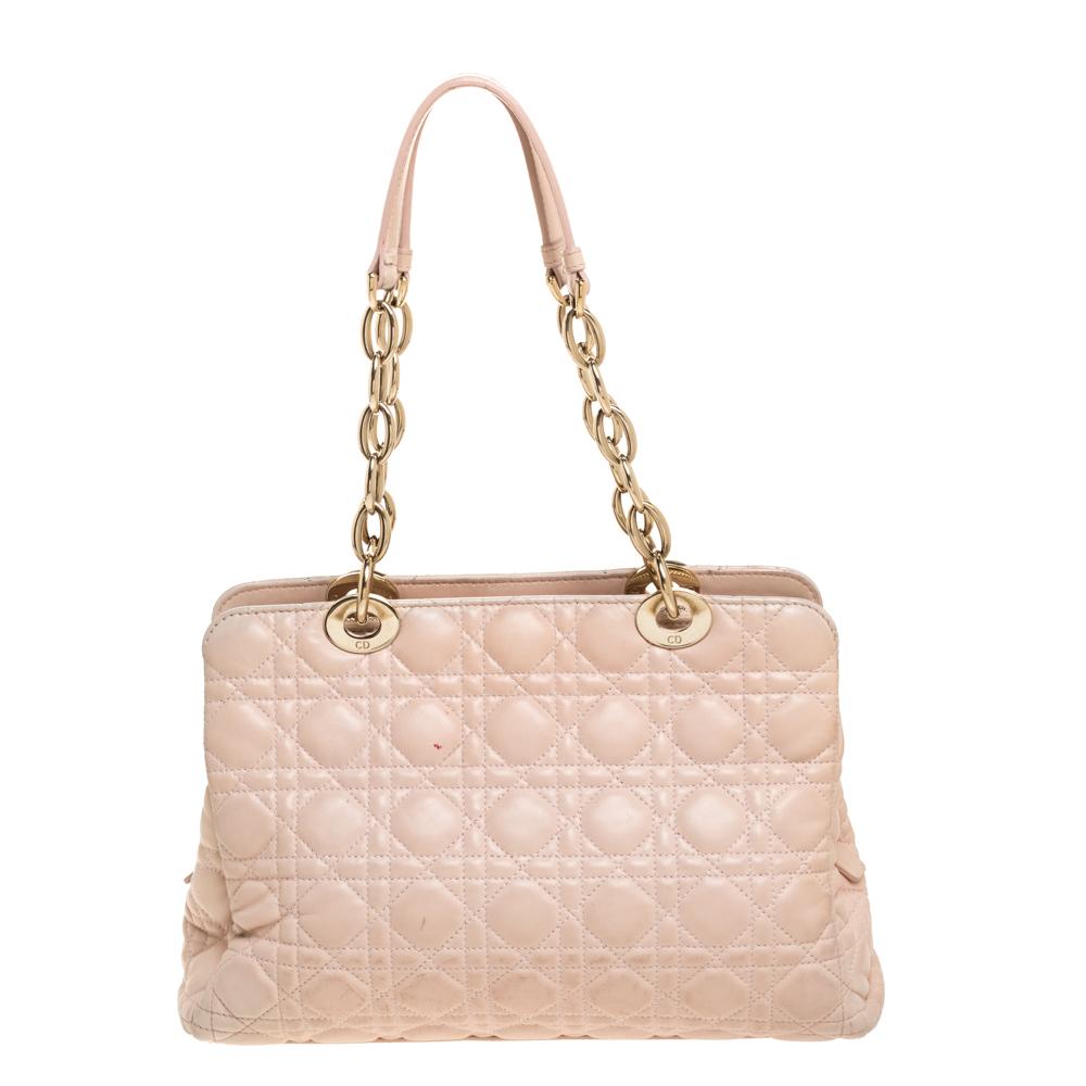 The Lady Dior tote is a Dior creation that has gained recognition worldwide and is today a coveted bag that every fashionista craves to possess. This beige tote has been crafted from leather and it carries the signature Cannage quilt. It is equipped