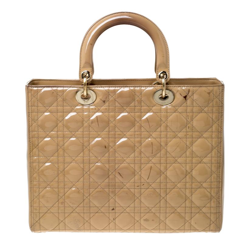 The Lady Dior tote is a Dior creation that has gained recognition worldwide and is today a coveted bag that every fashionista craves to possess. This beige tote has been crafted from patent leather and it carries the signature Cannage quilt. It is