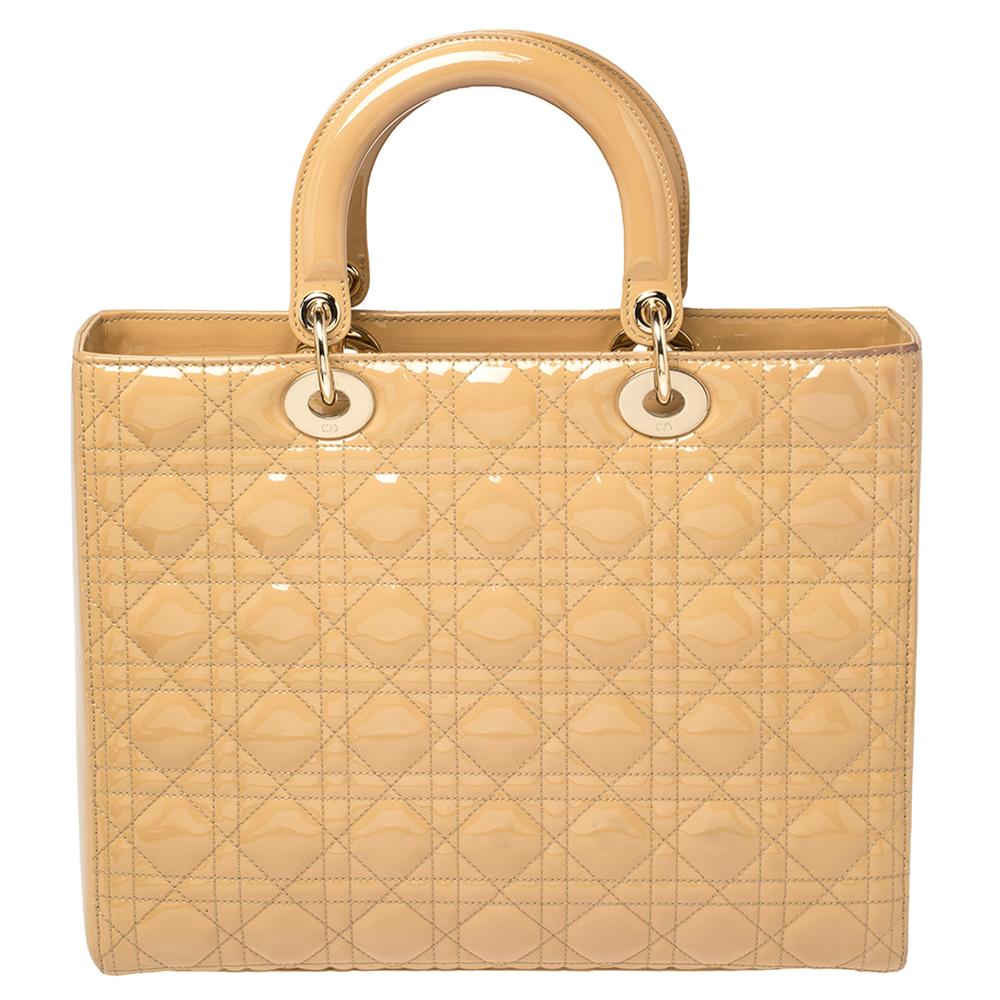 The Lady Dior tote is a Dior creation that has gained recognition worldwide and is today a coveted bag that every fashionista craves to possess. This beige-hued tote has been crafted from patent leather and it carries the signature Cannage quilt. It
