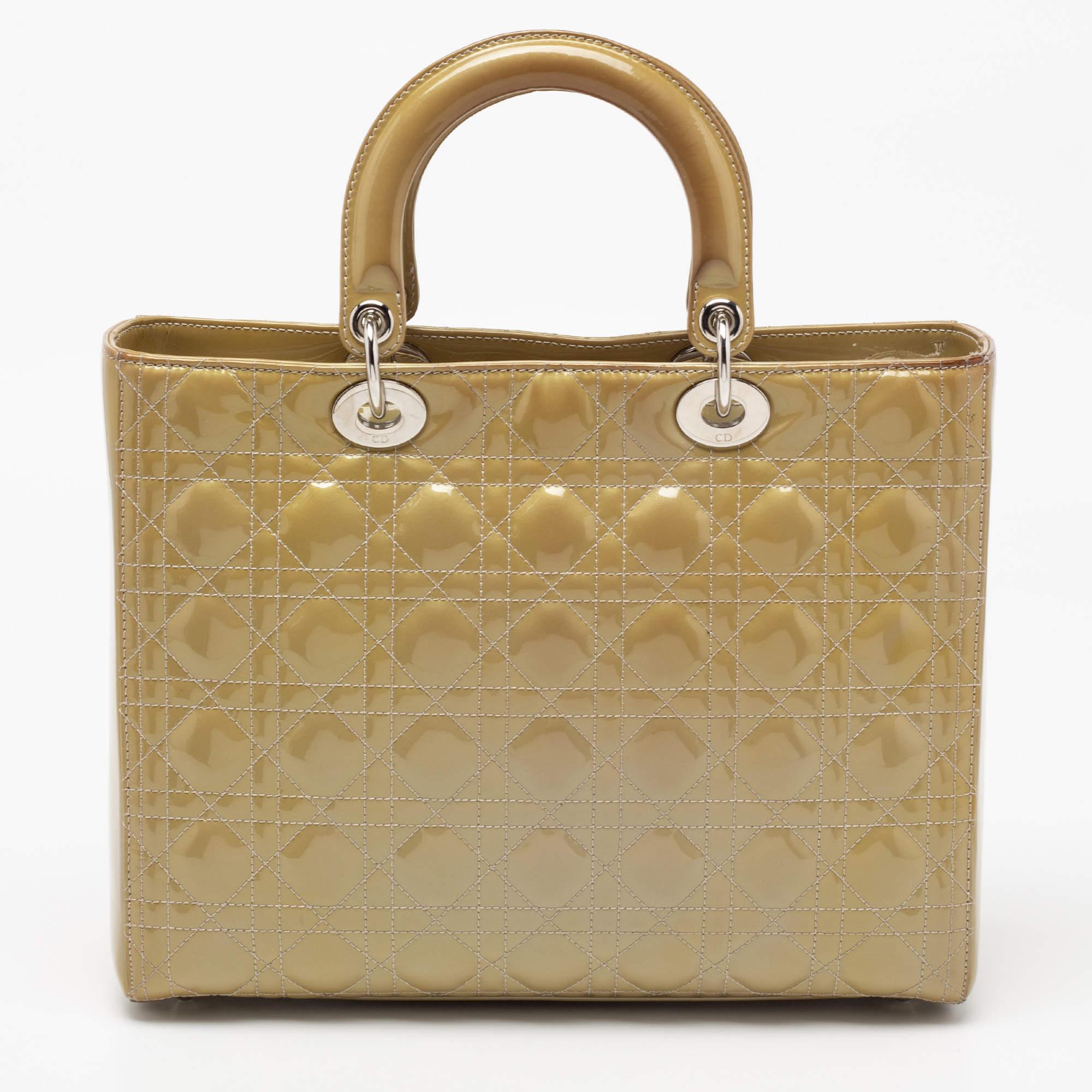 The Lady Dior tote is a Dior creation that has gained wide recognition and is a coveted bag that every fashionista craves to possess. The beige tote has been crafted from patent leather and carries the signature Cannage quilt. It is equipped with a