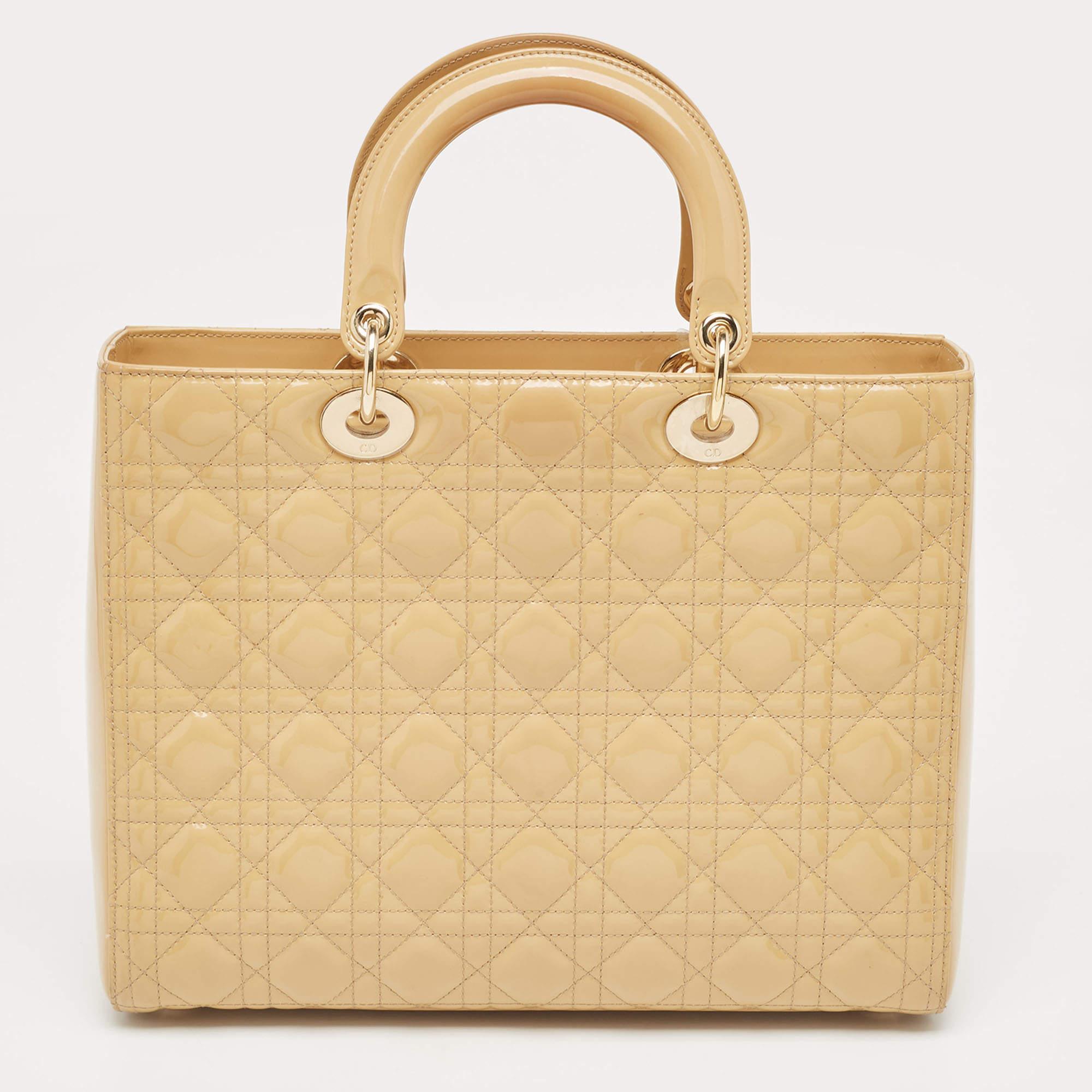 A timeless status and great design mark the Lady Dior tote. It is an iconic bag that people continue to invest in to this day. We have here this classic beauty crafted from beige Cannage patent leather. The bag has a lined interior for your