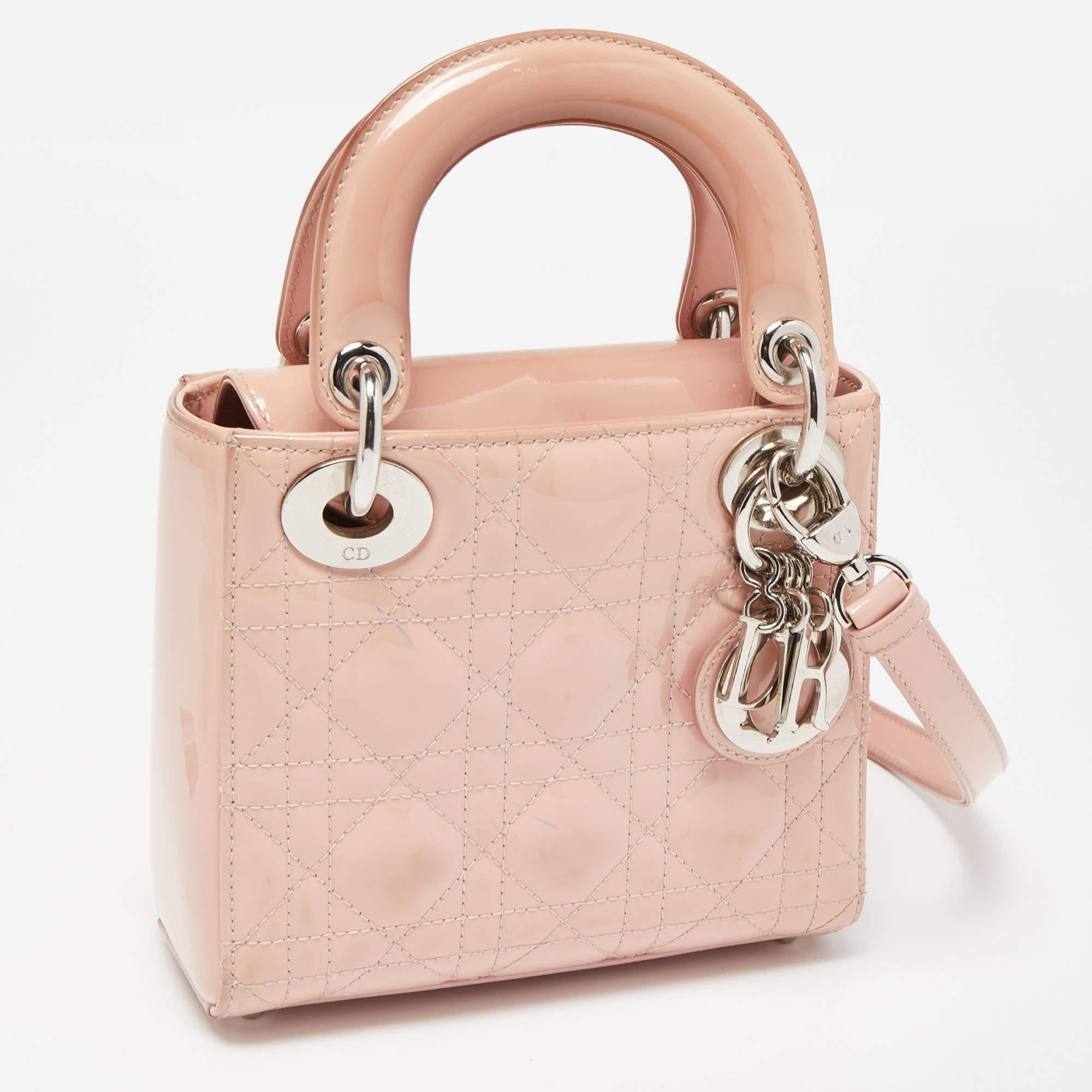 A timeless status and great design mark the Lady Dior tote. It is an iconic bag that people continue to invest in to this day. We have here this classic beauty crafted from beige Cannage patent leather. This mini Lady Dior is complete with two top