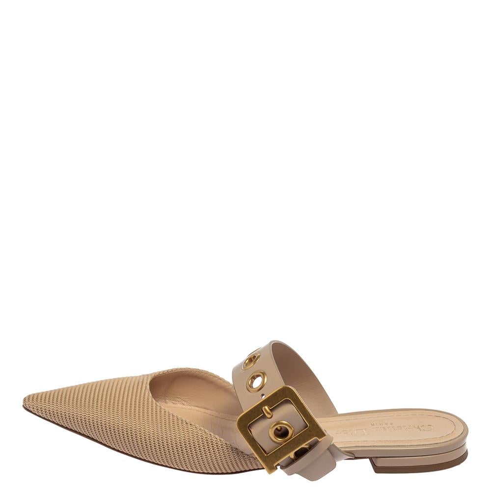 A gorgeous pair of D Dior mules from the house of Dior to highlight your fabulous styling choices. Match your outfit with these beige flats that come designed with pointed toes covered in fabric and buckled straps in leather. This pair is finished
