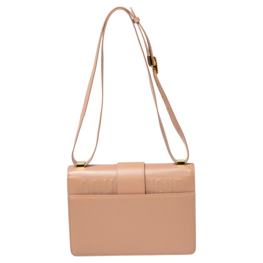 Inspired by the House's hallmark address, this Dior 30 Montaigne shoulder bag is the true embodiment of grace and luxury. The bag features a beige leather exterior and a gold-toned CD metal clasp on the front that derives its design from the seal of