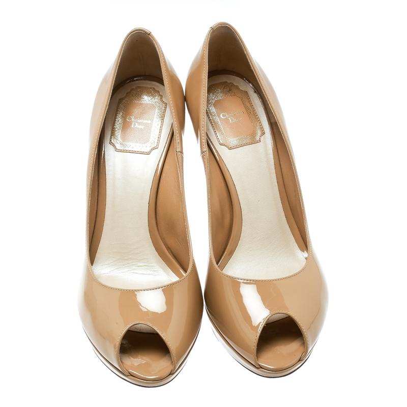 Every woman needs a pair of classy nude pumps and these Christian Dior Miss Dior peep-toe pumps fit the bill perfectly. Made from patent leather, these pumps feature comfortable platforms and 11 cm heels. The insoles are lined with leather and