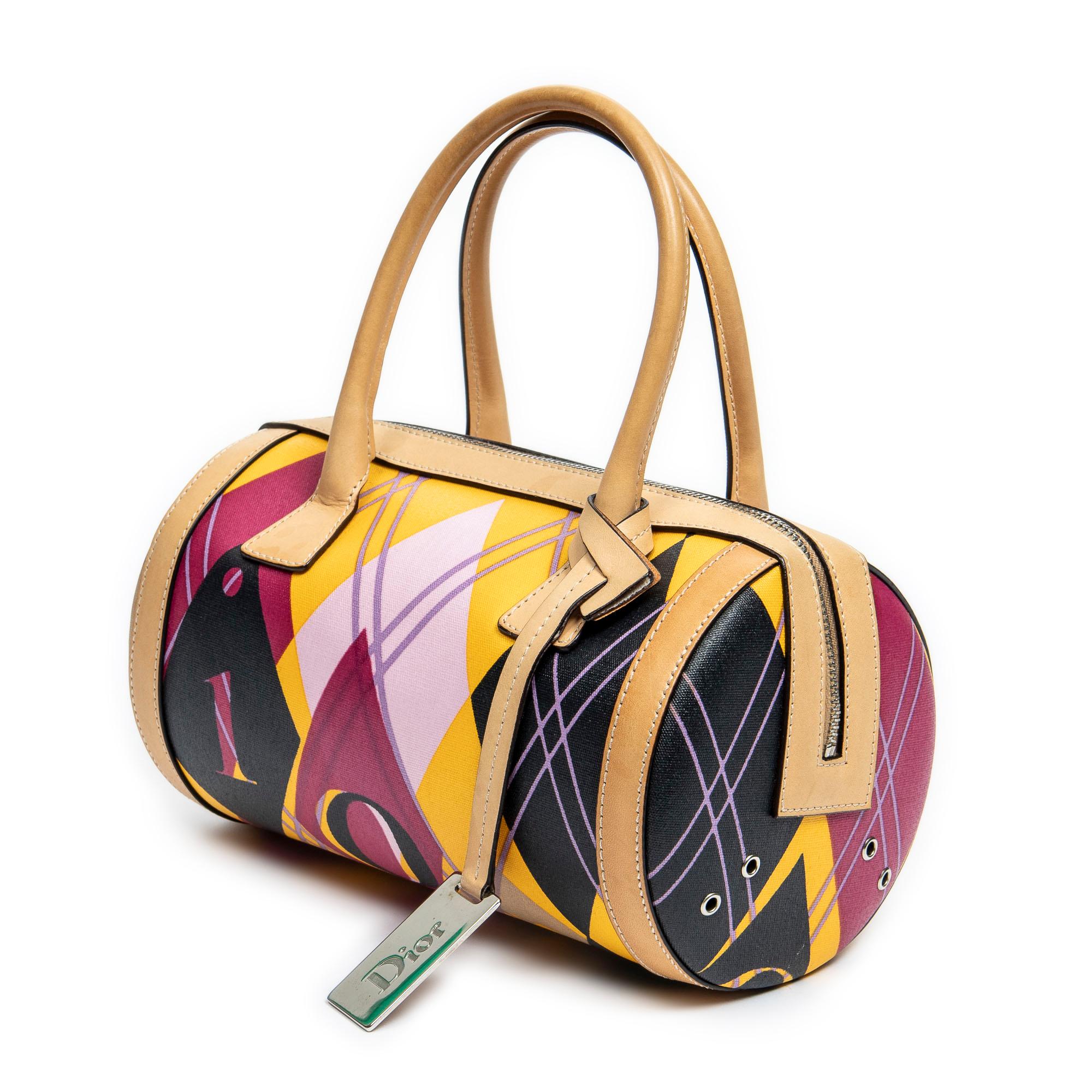 Introducing the Dior Beige/Pink/Black/Yellow Mini Golf Bowling Bag: a playful fusion of style and sophistication. Crafted from eye-catching argyle print coated canvas in a vibrant palette of beige, pink, black, and yellow, this bag exudes youthful
