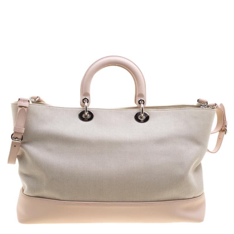 Look elegant and feminine wearing this Dior Nappy diaper bag is big enough to hold all that you need and more along with a beautiful design that will never let your down. Crafted in beige canvas and accented with pink leather, this bag features a
