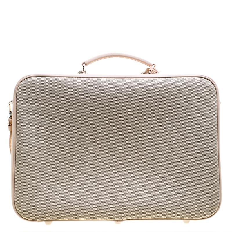 This Dior's Nappy suitcase is the best travel companion for those weekend trips. It features a beige canvas body trimmed with pink leather and comes with a top handle as well as a shoulder strap. The dual zip around closure opens to a leather lined