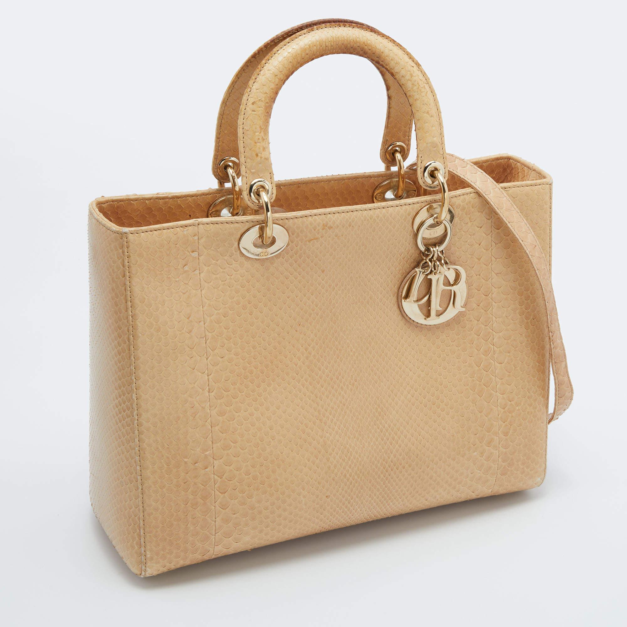 A timeless status and great design mark the Lady Dior tote. It is an iconic bag that people continue to invest in to this day. We have here this classic beauty crafted from beige python leather. The bag has a lined interior for your essentials. This