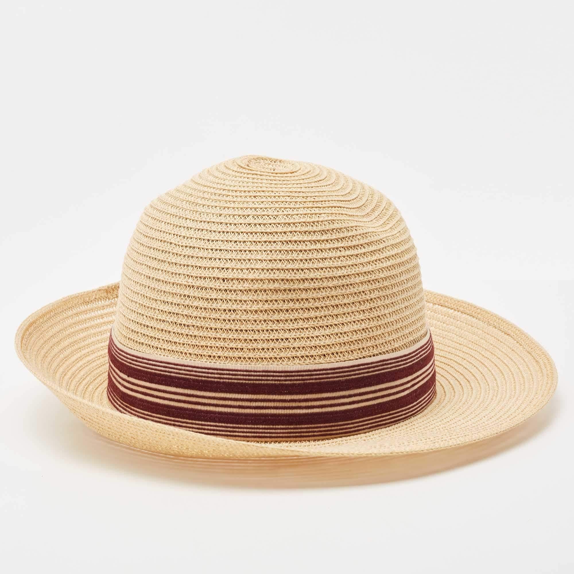 This hat by Dior is one accessory your summer wardrobe has been missing! It has been crafted from beige staw. It features a complementing ribbon band that encircles the hat. Be it picnics or beach vacations, it is sure to amp up your