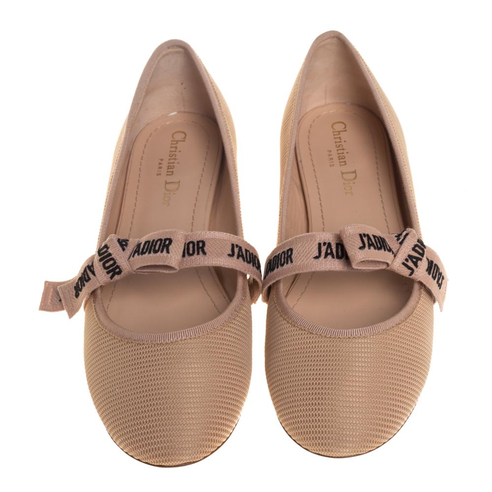 Endless compliments will come your way every time you wear these Dior ballerina flats. The beige flats are crafted from technical fabric and styled with round toes and 'J'Adior' bow ribbons on the vamps. They are complete with comfortable