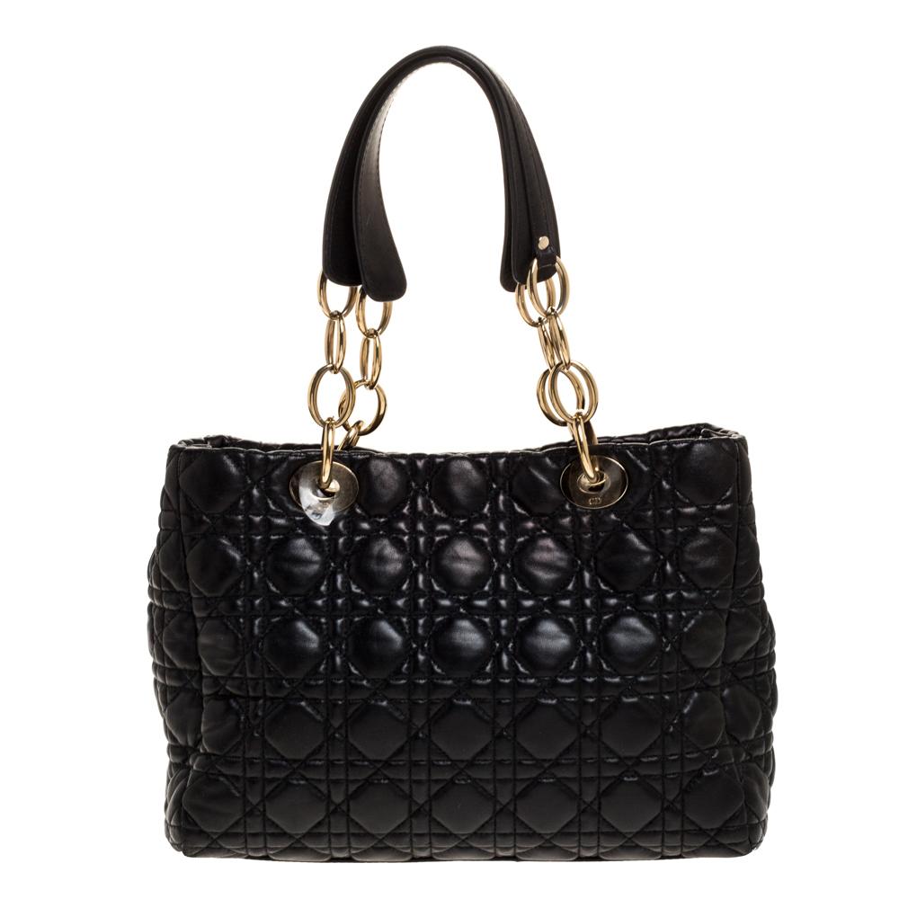 This shopper tote from Dior is a timeless piece. The bag is crafted from luxurious black leather and has the cannage pattern all over. It features double top handles, protective feet at the bottom, and Dior letter charm in gold-tone. A buttoned