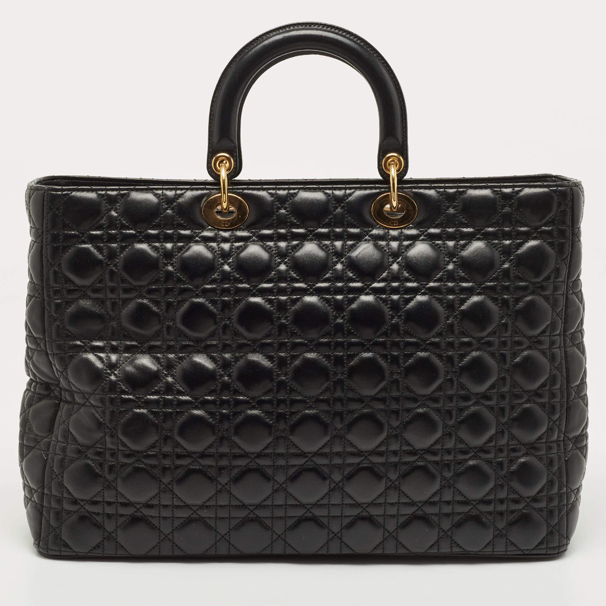 A timeless status and significant design define this impeccable Lady Dior tote. An iconic creation, this tote brings eternal poise, gracefulness, and elegance to your appearance. This version comes crafted in black Cannage leather, with gold-toned