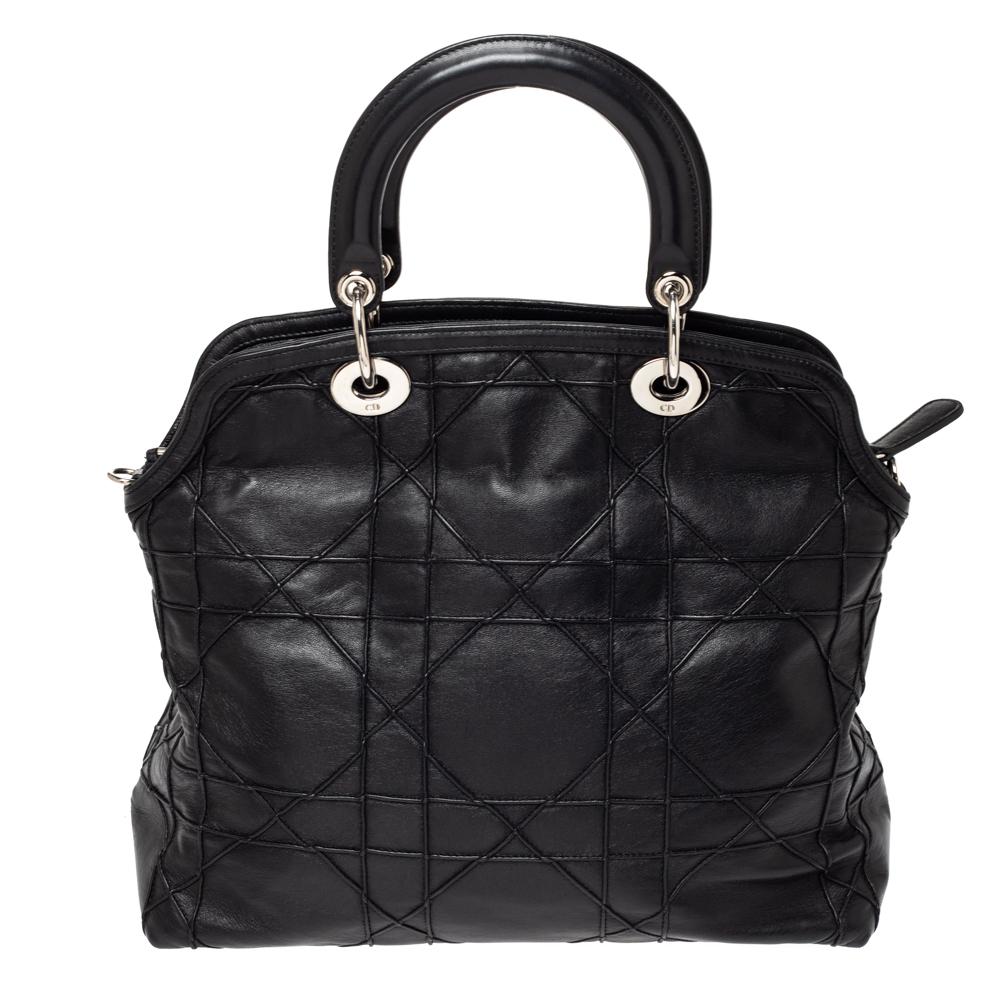 This Granville Polochon from Dior is a bag that every fashionista craves to possess. The bag has been crafted from leather and it carries a sleek black Cannage exterior. It is equipped with a leather interior, two rolled handles with a detachable