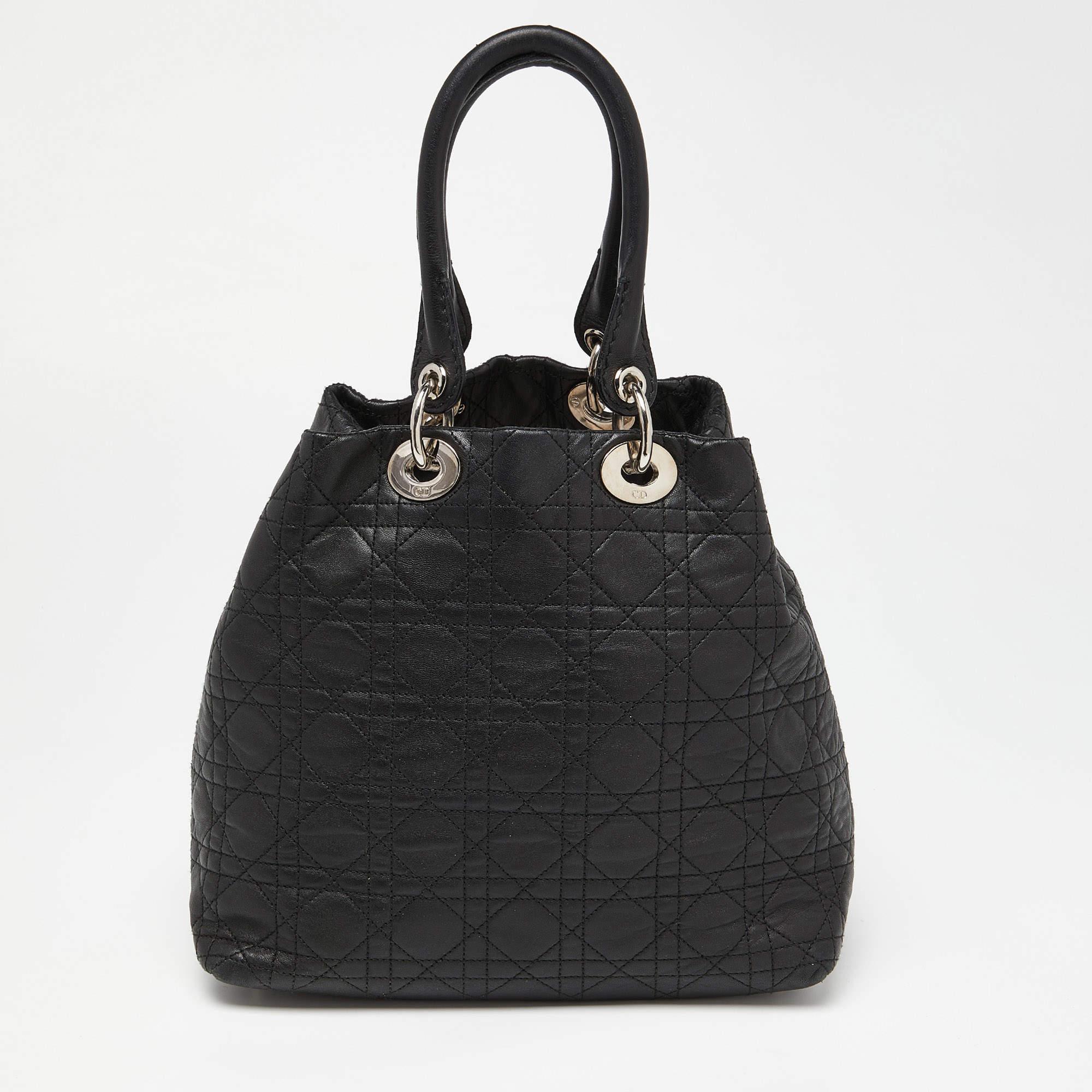 Perfect for work or travel, this Dior tote is made of Cannage leather to be classy and durable. It has dual handles, letter charms, and a nylon-lined interior.

