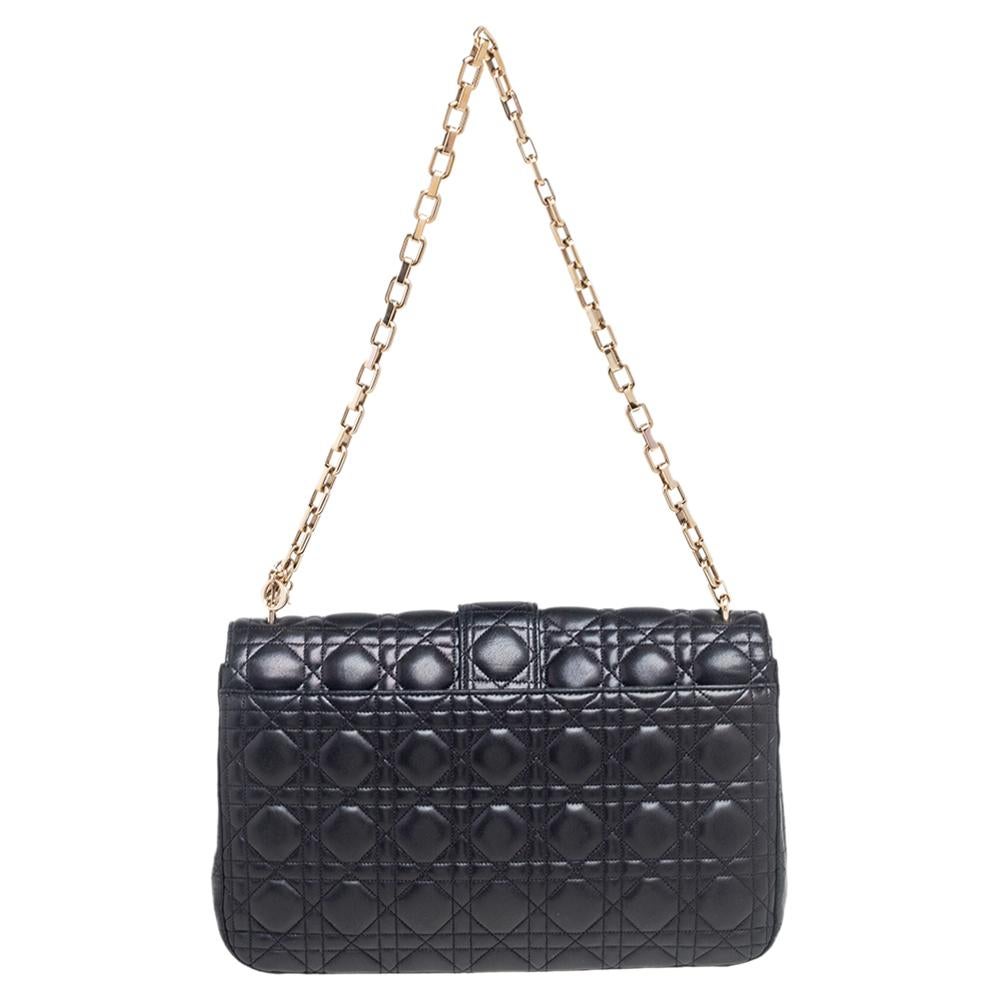 Flap bags like this Miss Dior will never go out of style. Crafted from leather, this Dior flap bag features a black Cannage exterior and a chain strap. The front flap has a Dior lock that opens to a leather-lined interior with enough space to keep