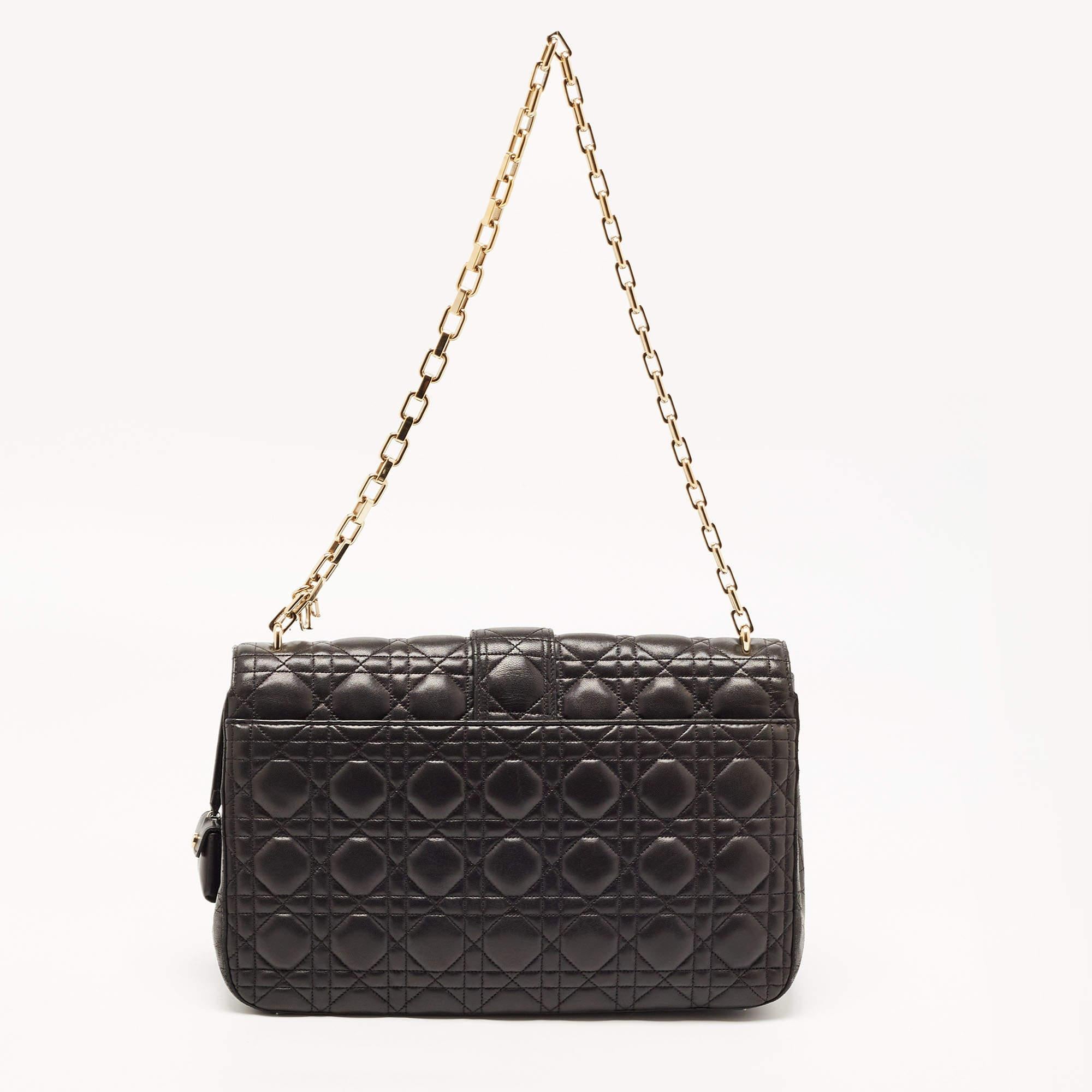 Bags like this Miss Dior will never go out of style. Crafted from leather, this Dior flap bag features a black Cannage exterior and a chain strap. The front flap has a Dior lock that opens to a leather-lined interior with enough space to keep your