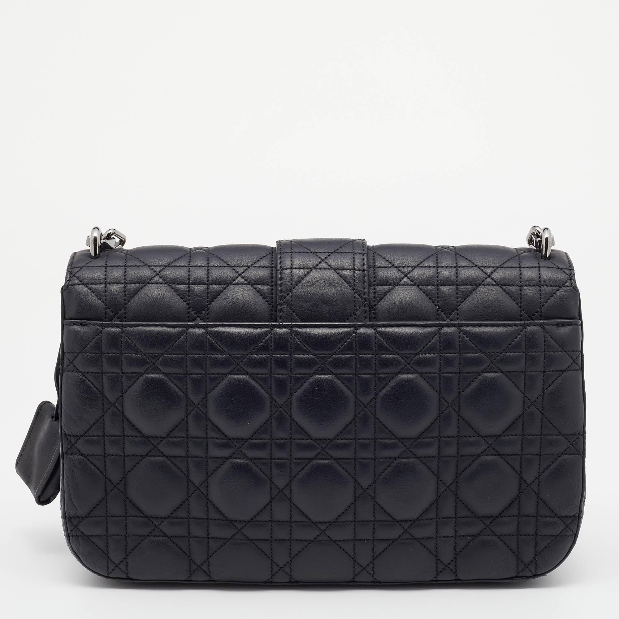 Flap bags like this Miss Dior hold the promise of enduring style, to be part of your forever collection. Crafted from leather, this Dior bag features a black Cannage quilted exterior and a chain-link strap. The front flap has a silver-tone lock that