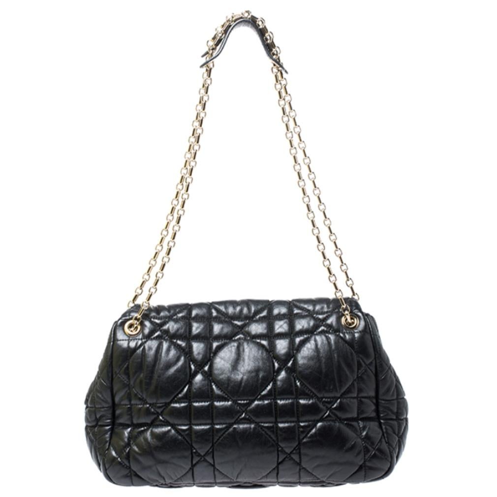 Add a classic bag to your wardrobe with this Dior shoulder bag. It is chic, reliable and will go with any of your outfits. It features Dior's signature cannage pattern on the black leather exterior, double chain handles with leather shoulder rests