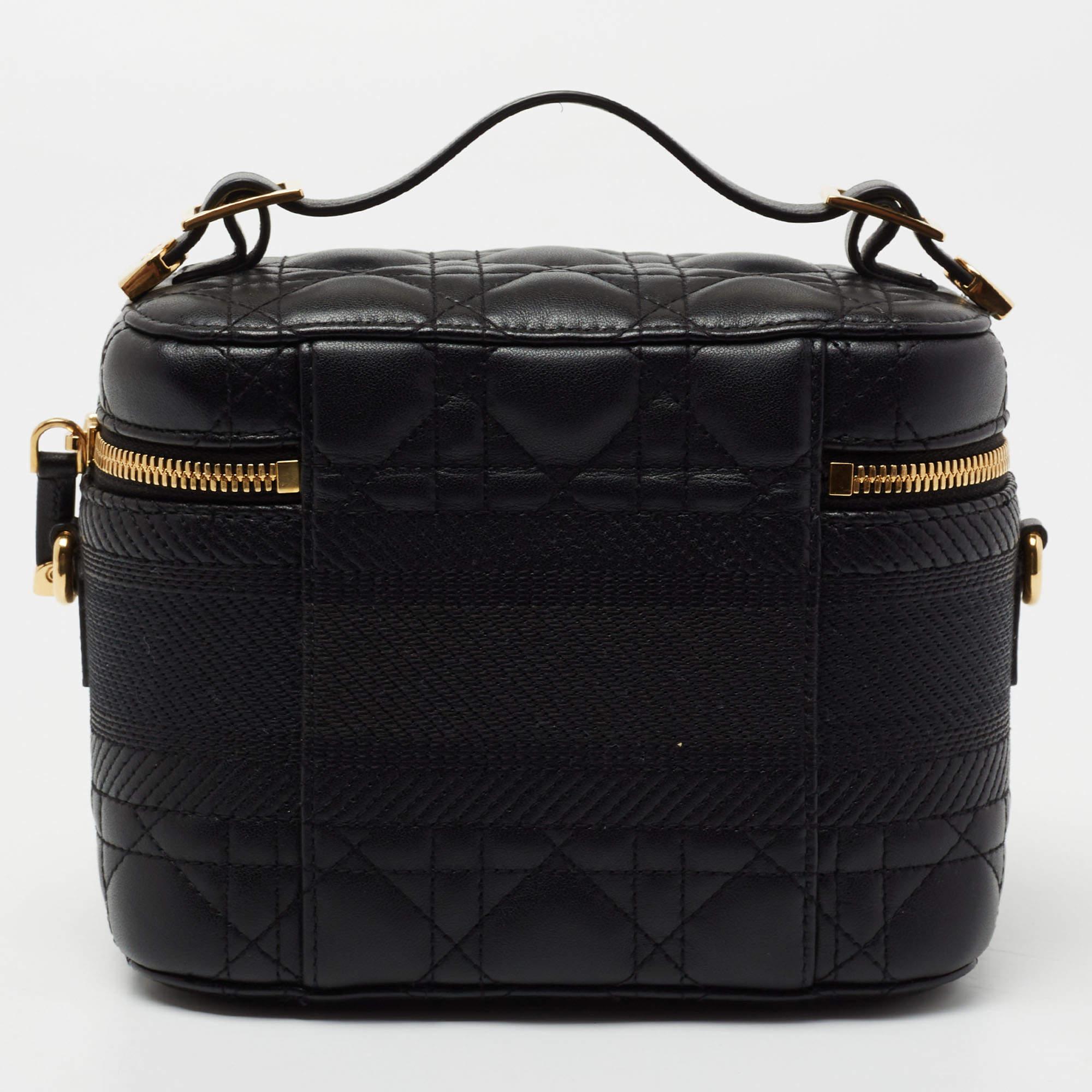 Defined by an architectural silhouette, this Diortravel vanity case is infused with eye-catching elements. Its black exterior gets a luxe update with the Cannage motif for its construction and the brand name on the front. Holding an ever-lasting
