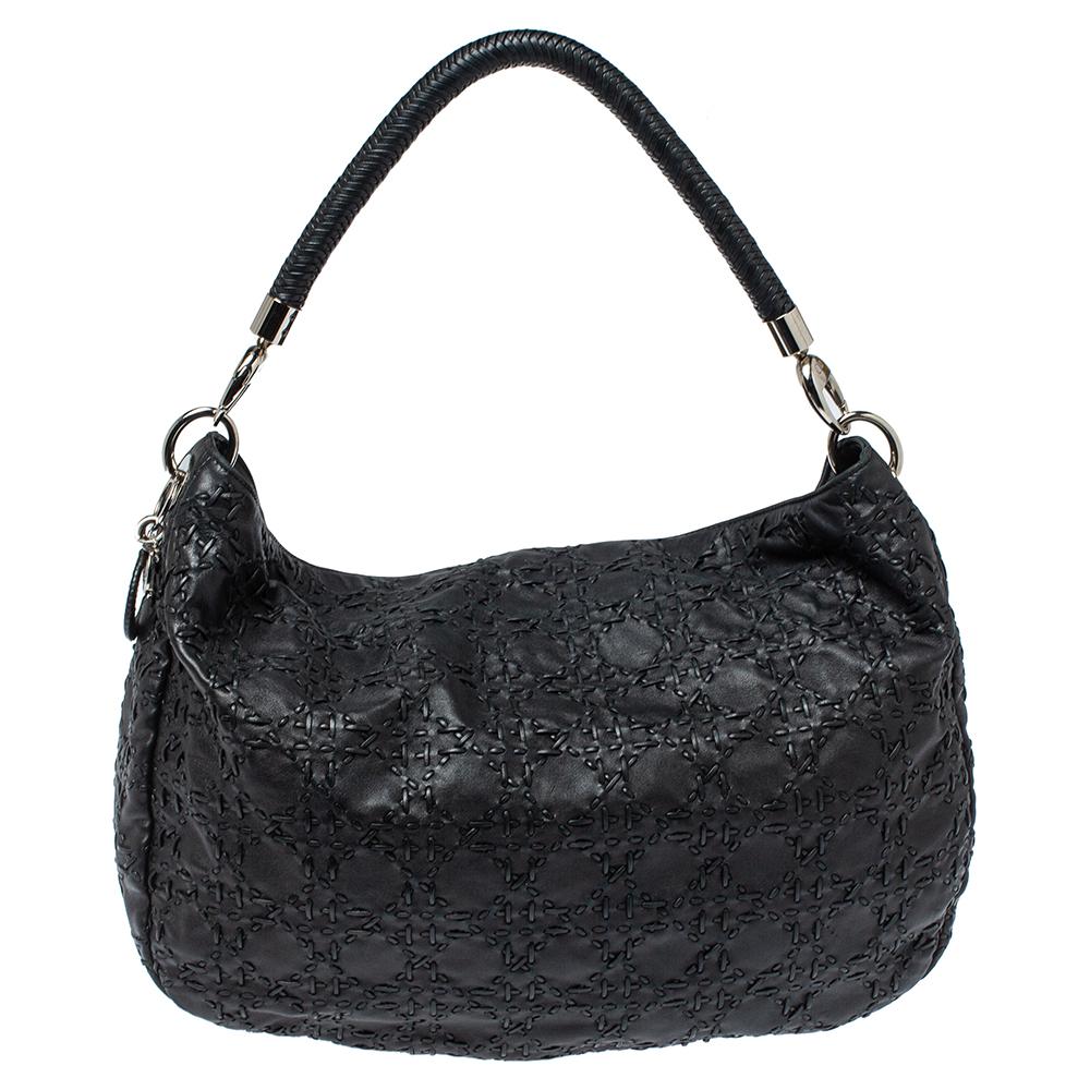 This Dior hobo will make a splendid addition to your bag collection. It is crafted from durable leather and is beautifully designed with whipstitch Cannage detailing. The bag has a top zip fastening that leads to a well-sized interior featuring