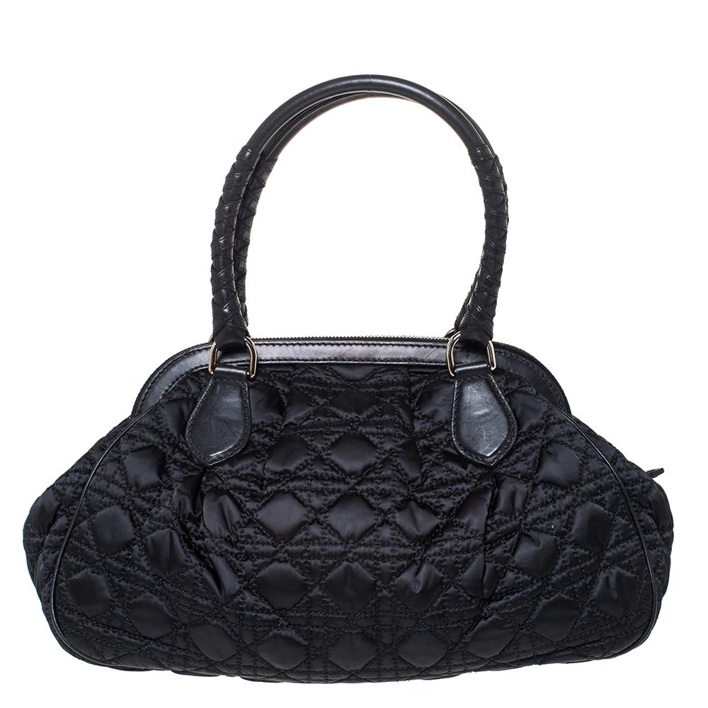 Dior’s take on the classic doctor bag, this vintage-inspired Dior quilted nylon bag has a capacious compartment to hold your daily accompaniments. It features the signature cannage quilted pattern and is nicely finished with braided details on the