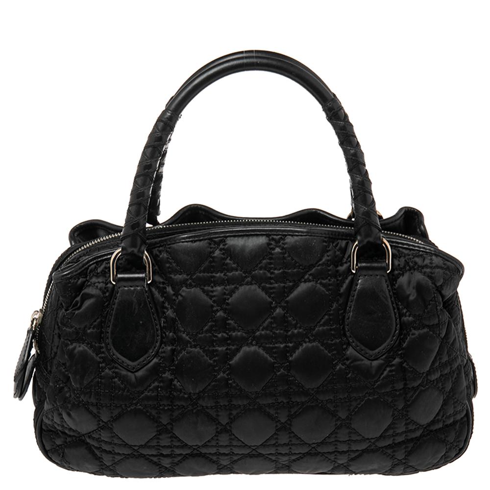 Dior’s take on the classic doctor bag, this vintage-inspired Dior quilted nylon bag has a spacious compartment to hold your daily accompaniments. It features the signature cannage quilted pattern and is nicely finished with braided rolled, top