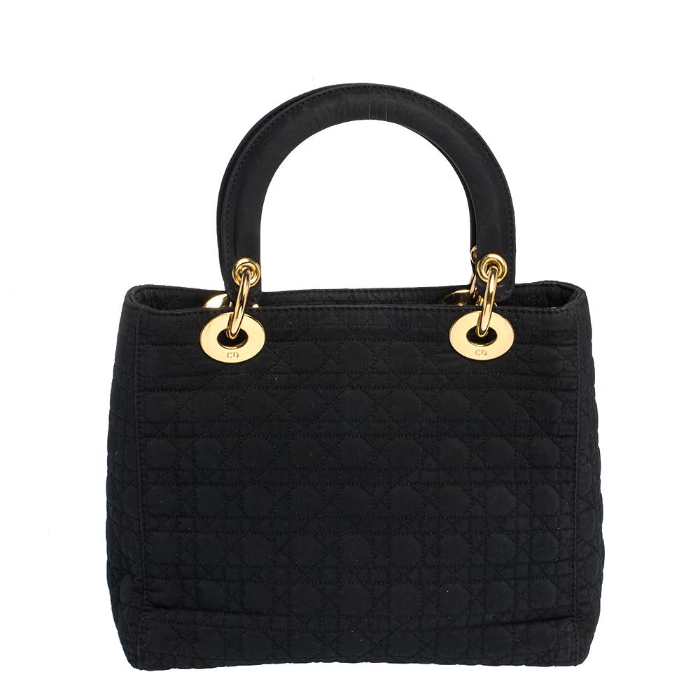 The Lady Dior tote is a Dior creation that has gained recognition worldwide and is today a coveted bag that every fashionista craves to possess. This black tote has been crafted from nylon and it carries the signature Cannage quilt. It is equipped