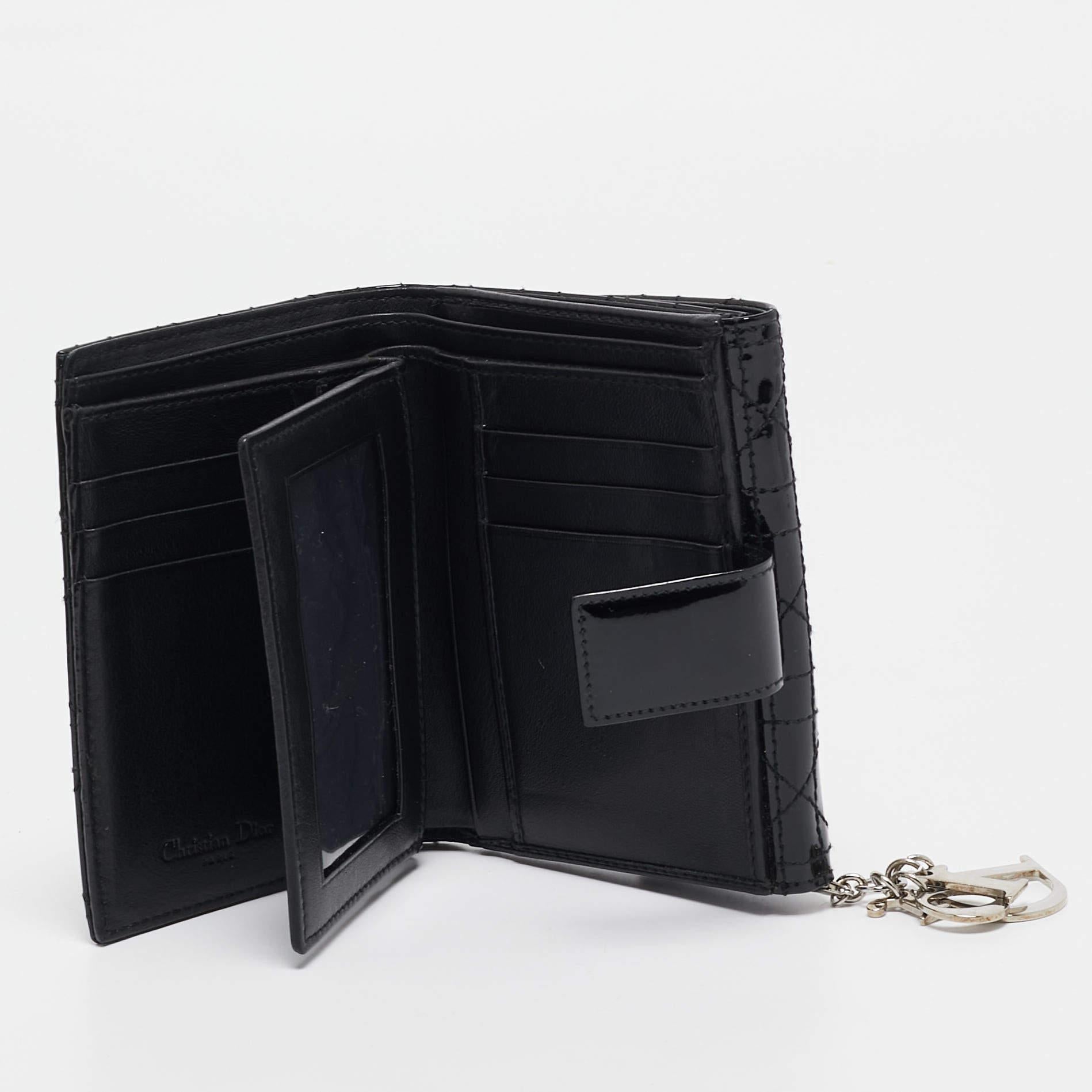 Infuse the signature aesthetics of Dior into your outfit by accessorizing it with this wallet. With a classic design and a contemporary shape  this Lady Dior is crafted from Cannage leather  and the brands letter charms mark the faultless