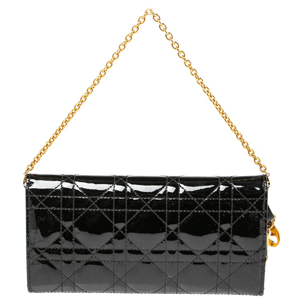 This Lady Dior wallet is a coveted bag that every fashionista craves to possess. This black beauty has been crafted from patent leather and it carries the signature Cannage quilt. It is equipped with a fully lined interior featuring several card