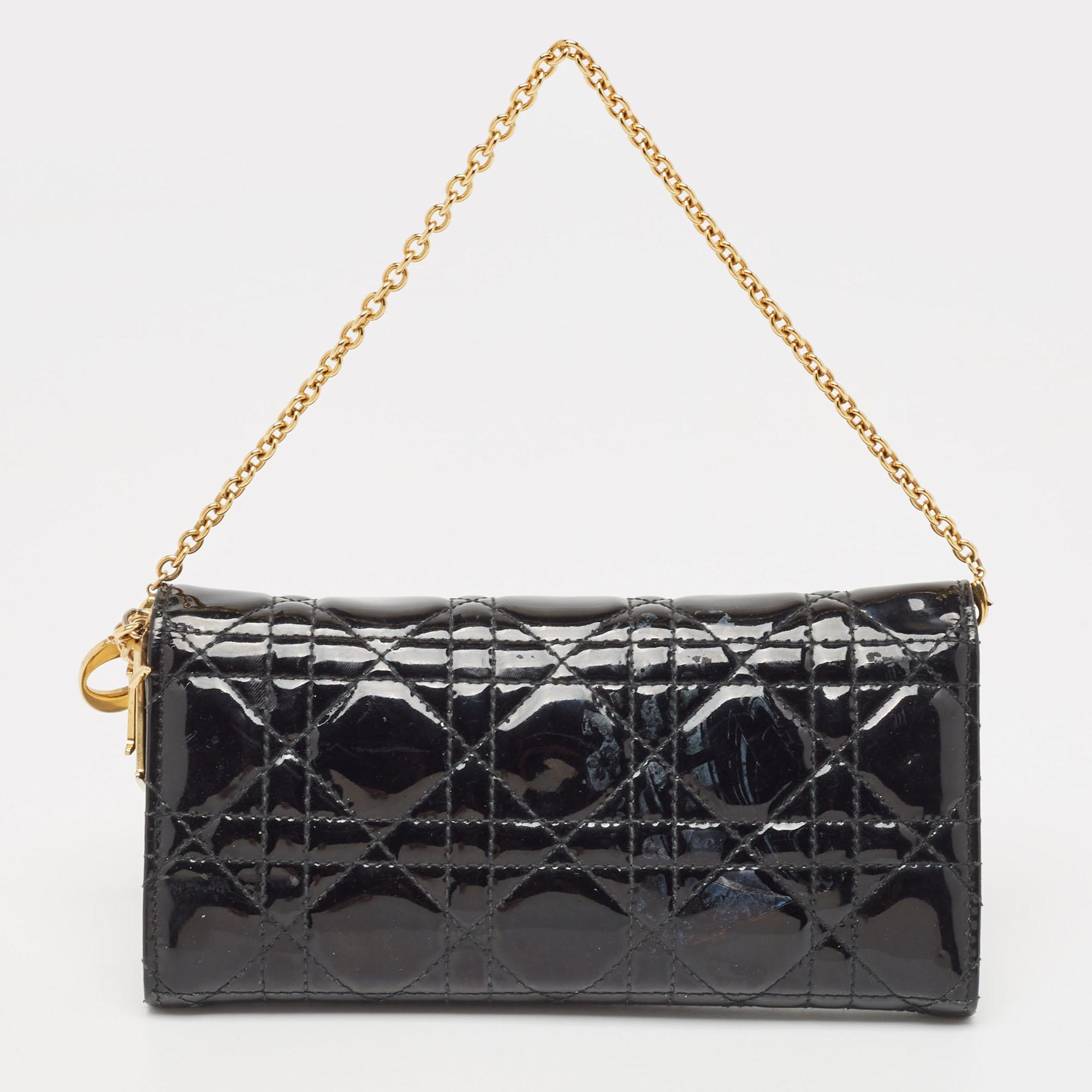 This Lady Dior wallet on chain is a coveted bag that every fashionista craves to possess. This black wallet has been crafted from leather and it carries the signature Cannage quilt. It is equipped with a leather & satin interior featuring multiple