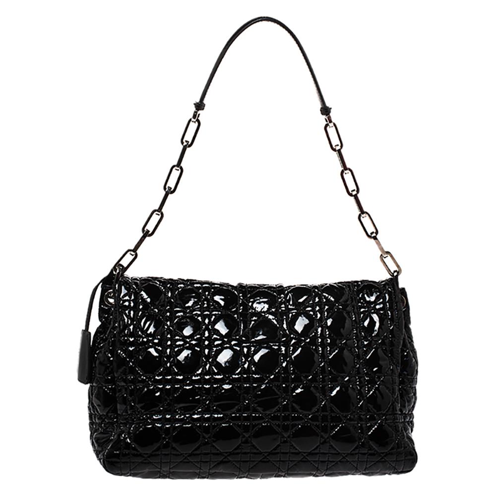 This Dior flap bag was named after 'New Look' which was actually coined by Christian Dior himself. Dazzling in a gorgeous black shade, the bag is crafted from patent leather in their Cannage pattern and designed with a single handle and a front