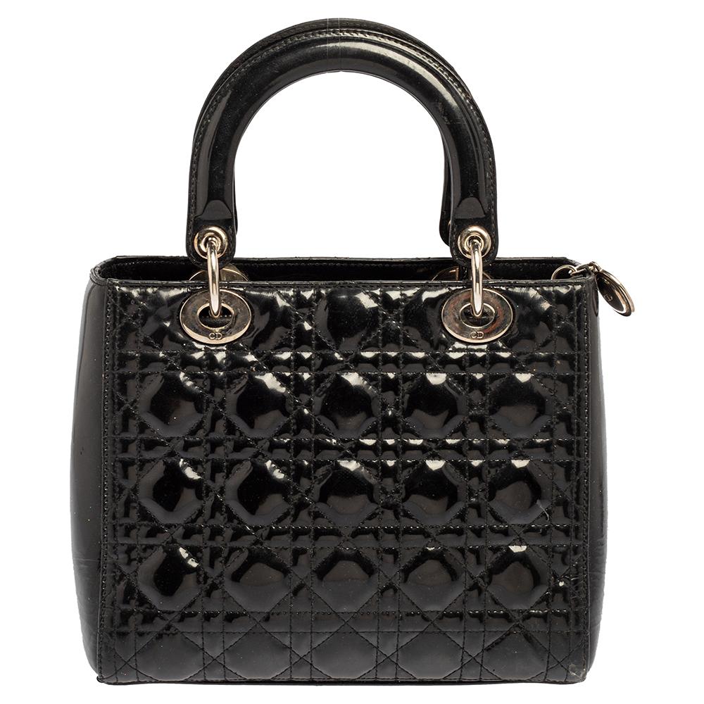 The Lady Dior tote is a Dior creation that has gained recognition worldwide and is today a coveted bag that every fashionista craves to possess. This black tote has been crafted from patent leather and it carries the signature Cannage quilt. It is