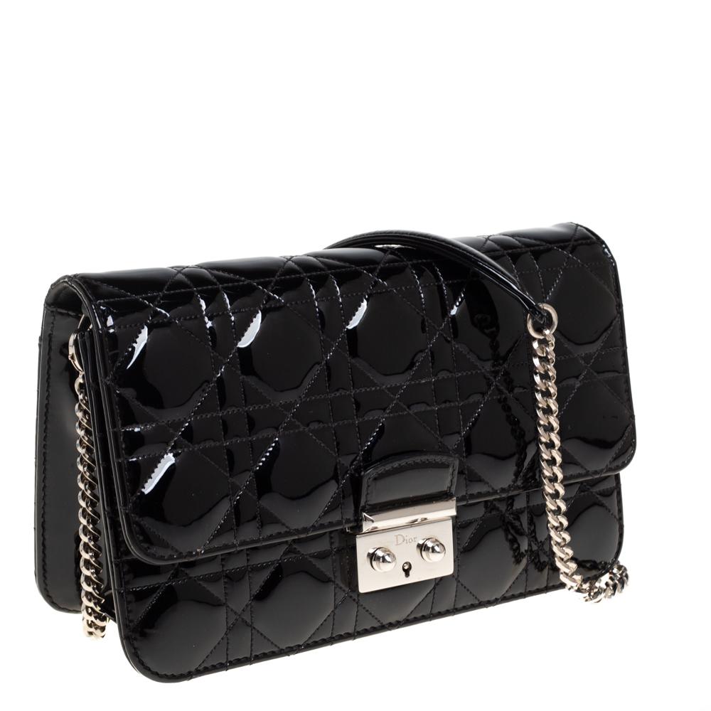 Flap bags like this Miss Dior will never go out of style. Crafted from patent leather, this Dior flap bag features a Cannage exterior and a chain strap. The front flap has a Dior lock that opens to a leather and fabric-lined interior with enough