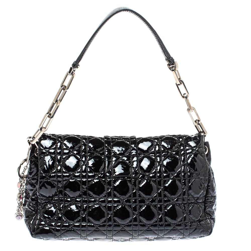 This Dior flap bag was named after 'New Look' which was actually coined by Christian Dior himself. Dazzling in a gorgeous black shade, the bag is crafted from patent leather in their Cannage pattern and designed with a single handle and a front