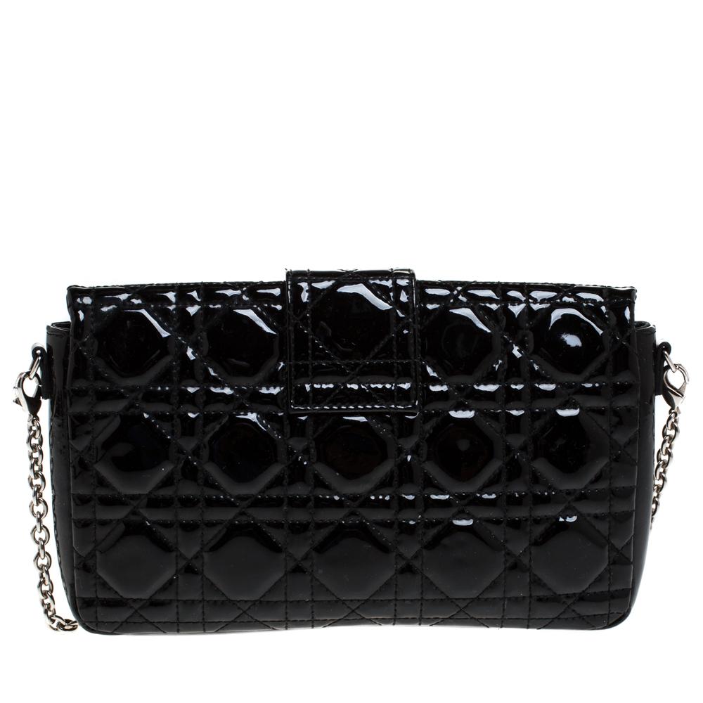 Flap bags like this Miss Dior will never go out of style. Crafted from patent leather, this Dior flap bag features a black Cannage exterior and a chain strap. The front flap has a Dior lock that opens to a leather-lined interior with enough space to