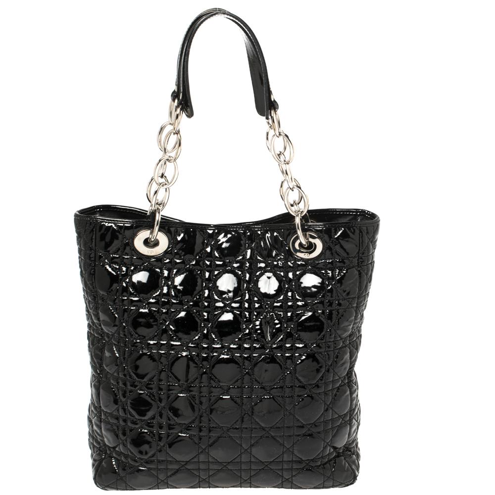 Combining functionality and style in one compact design, this patent leather Lady Dior tote is the perfect pick this season. The grommets and silver-tone chain give it an edge, while the cannage quilting makes it unmistakably Dior. The dangling DIOR